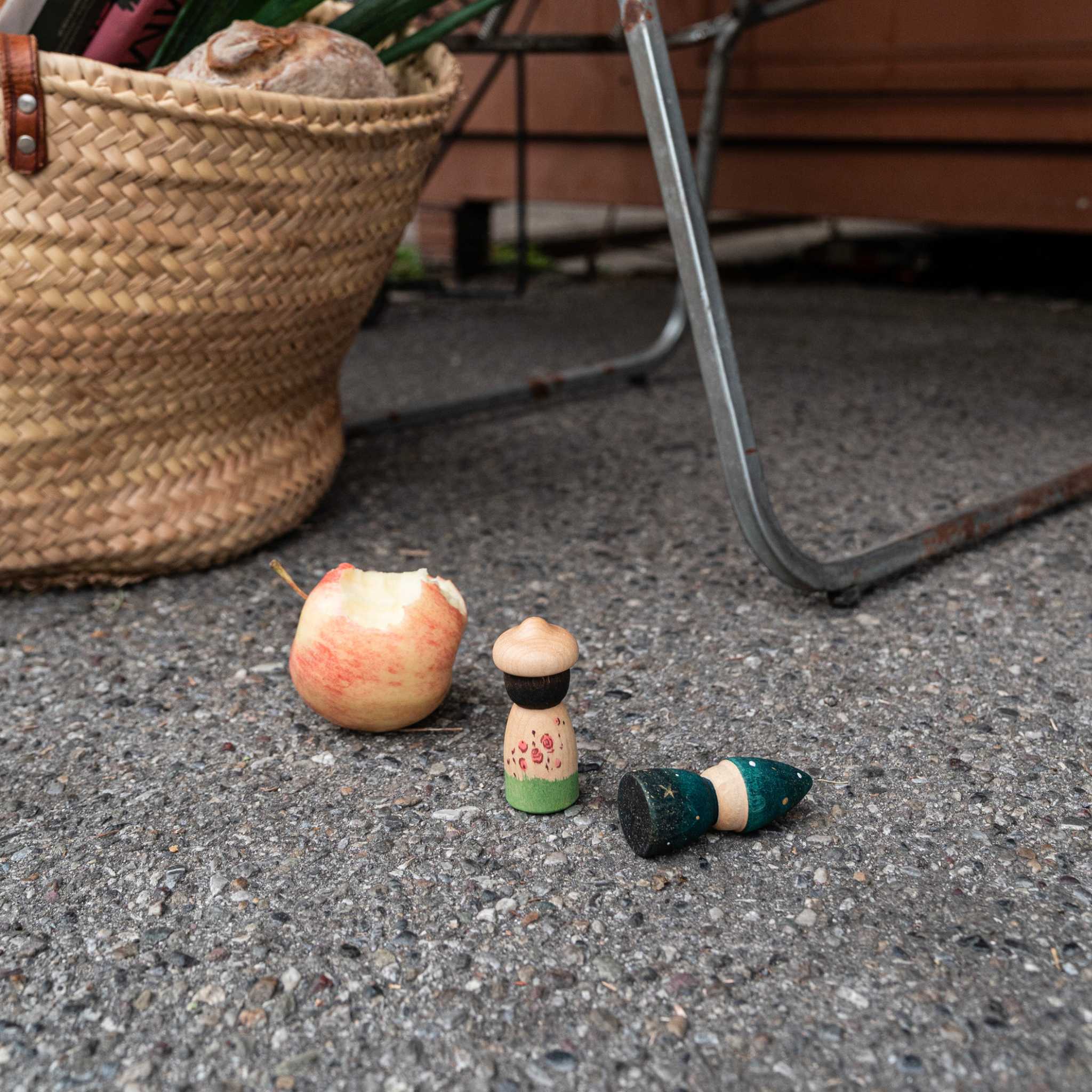 2 Grapat Lucky Lucky Peg Dolls on Floor With Apple
