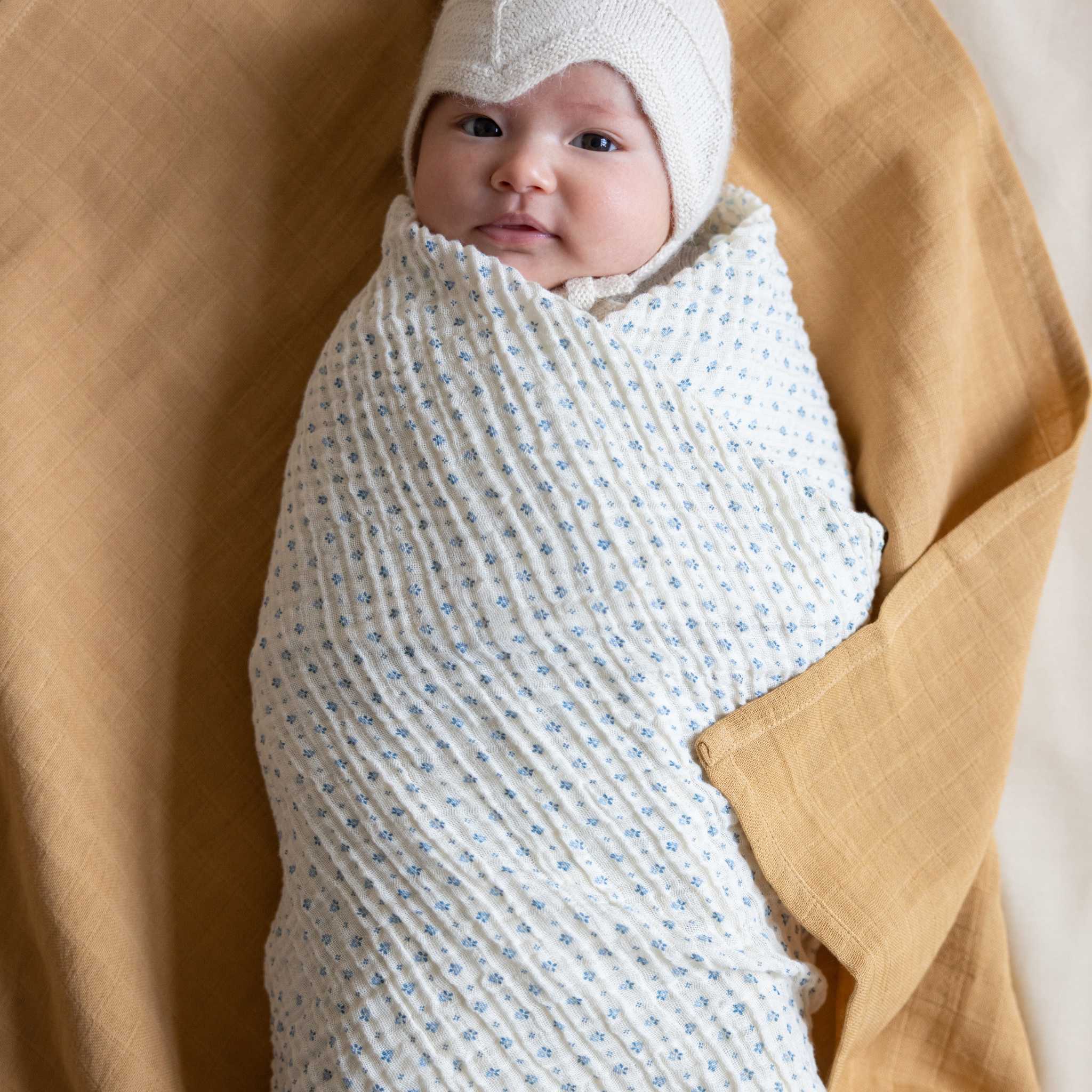 Cam Cam Capri Swaddle On Baby