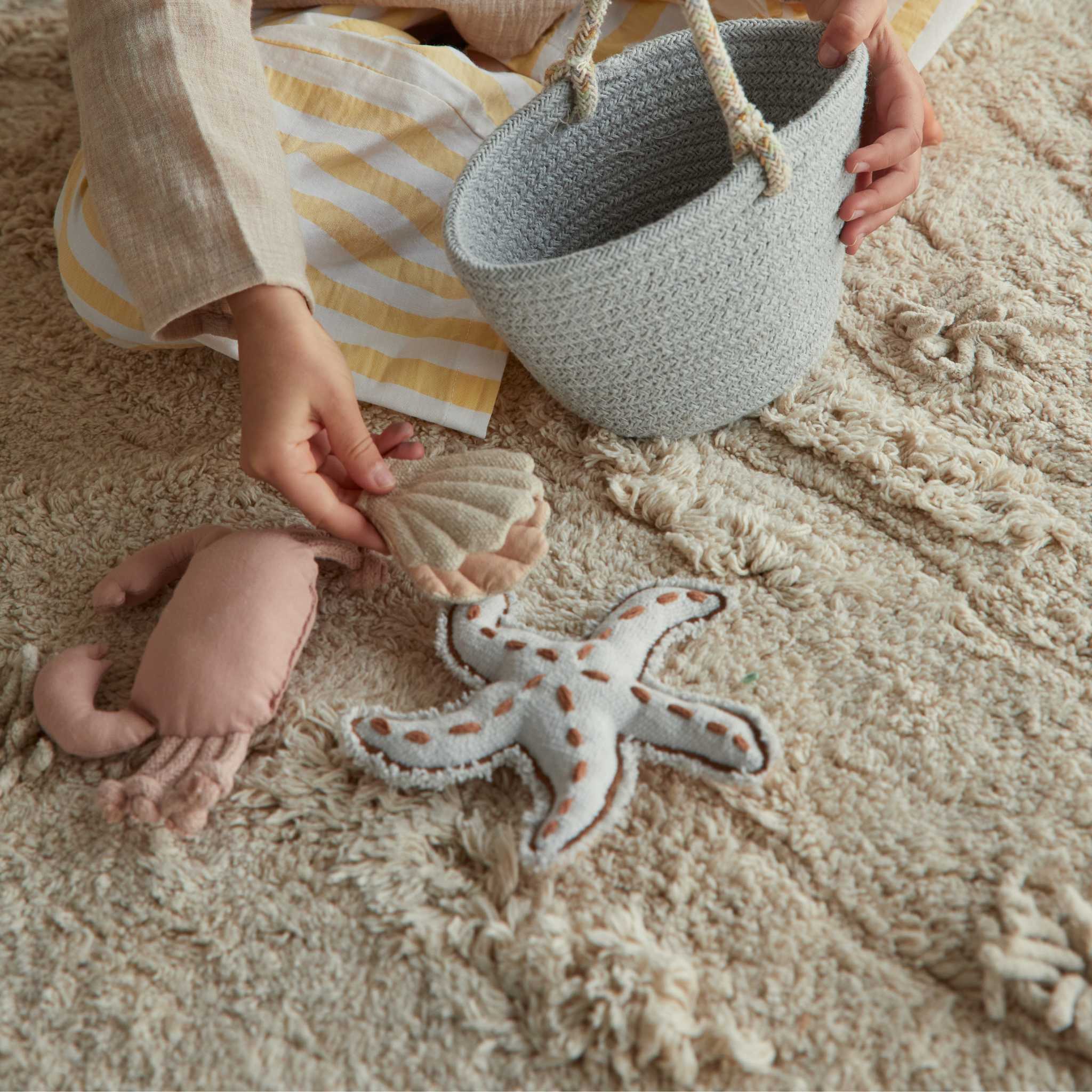 Child Playing With Elements From Lorena Canals Washable Play Rug Island