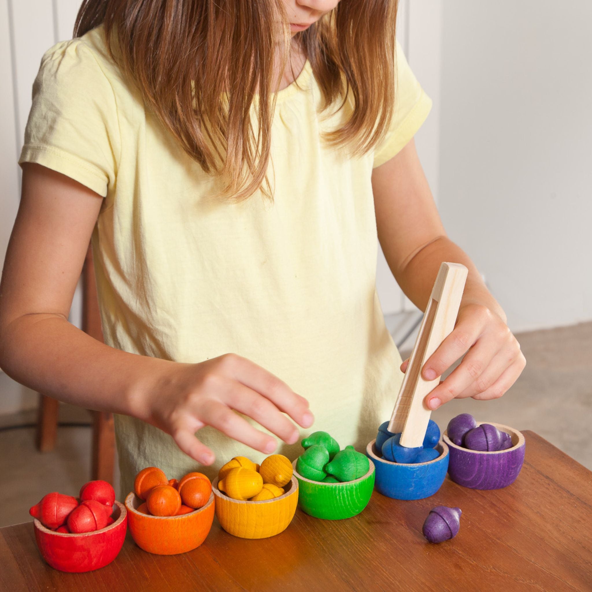 Girl Playing With Grapat Wooden Bowls and Acorns Set