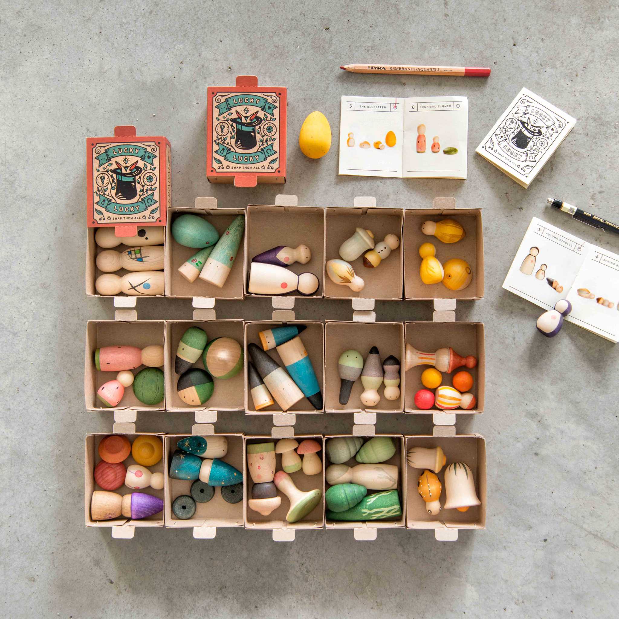 Grapat Lucky Lucky Boxes Open On Concrete Background With Pens And Booklets