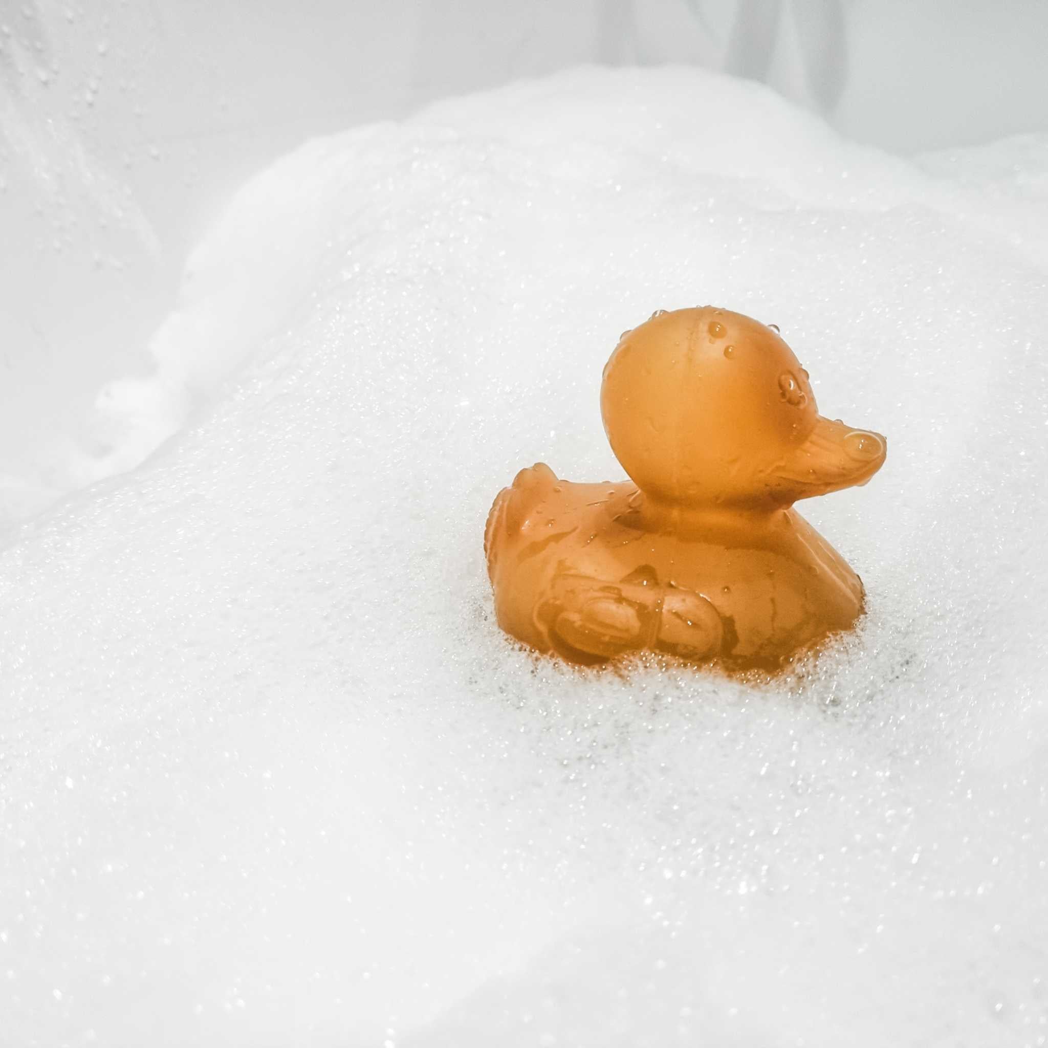 Hevea Alfie Natural Rubber Bath Toy Surrounded By Bubbles