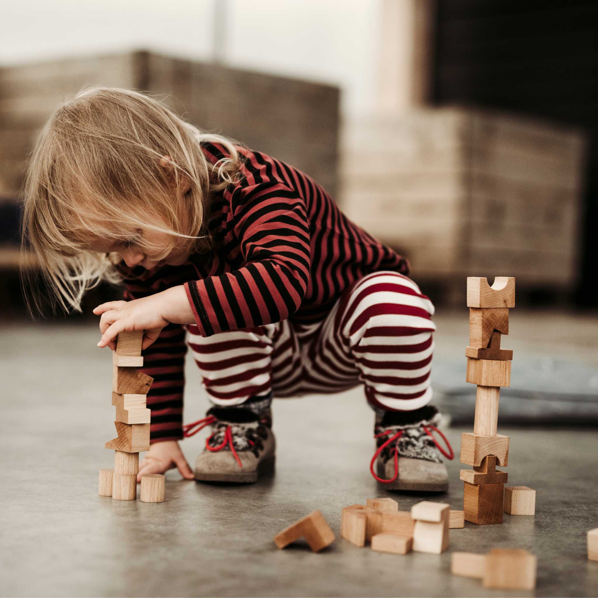 Kid Playing With Wooden Story Natural Stacking Tower