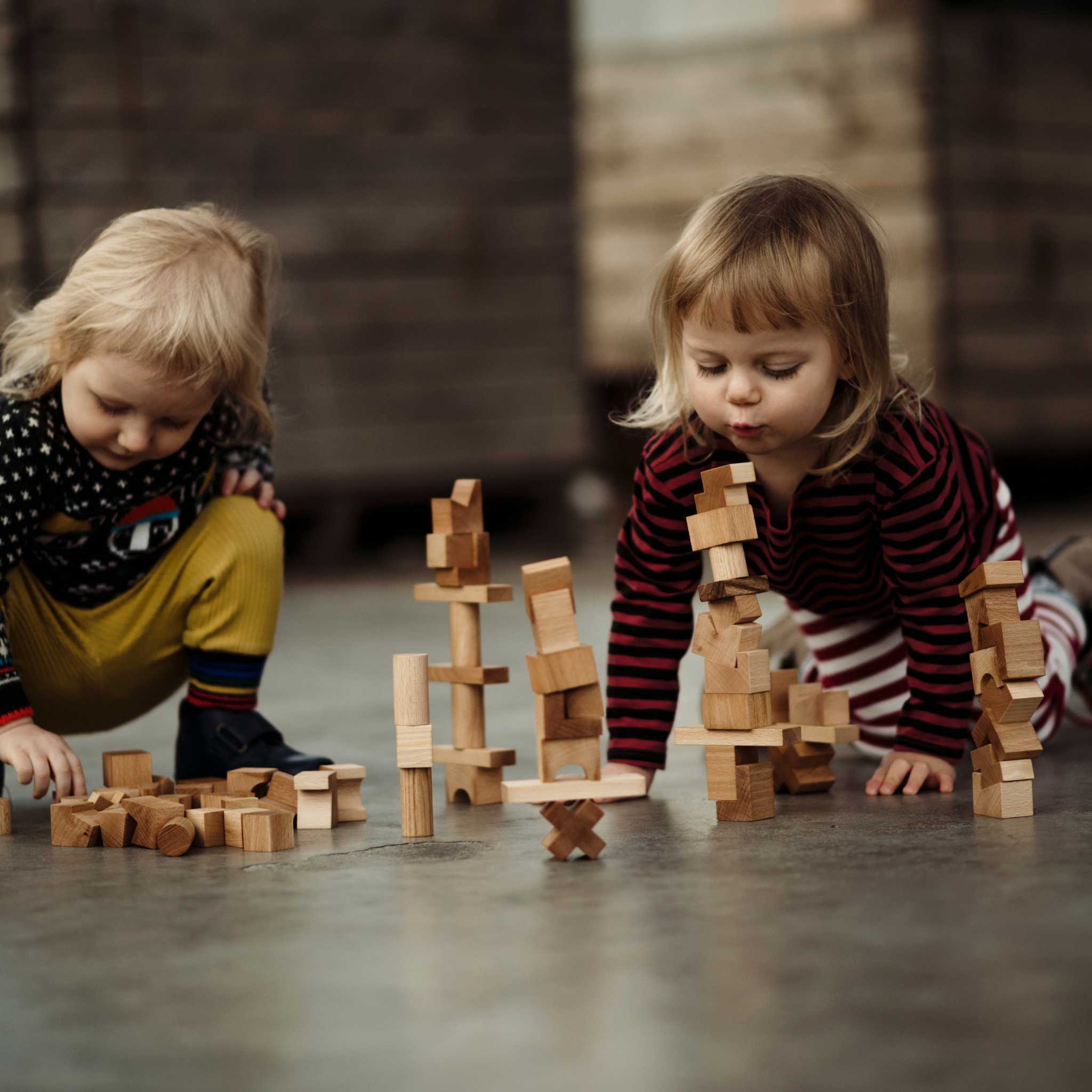 Kids Playing With Wooden Story Natural Stacking Tower 