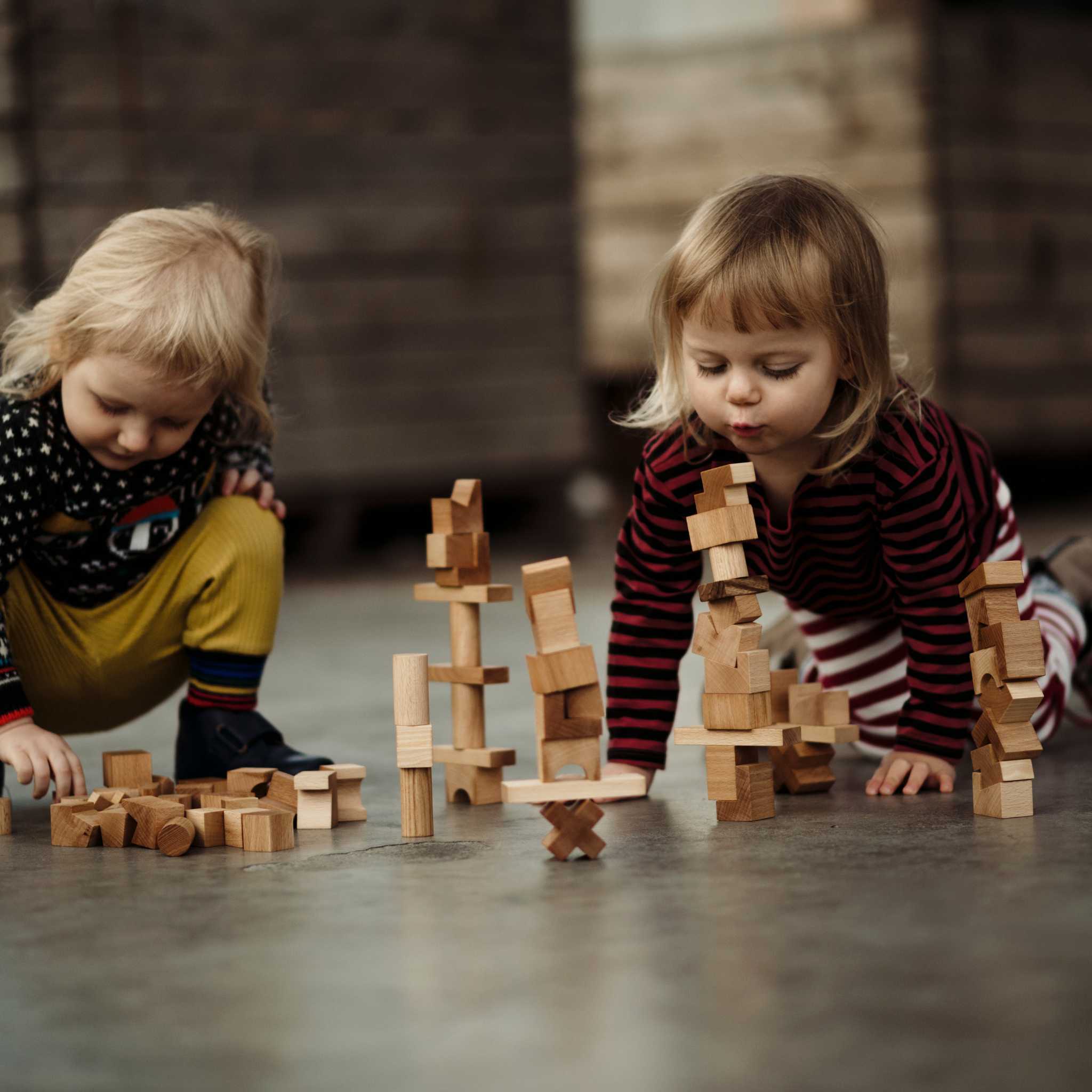 Kids Playing With Wooden Story Natural Stacking Tower