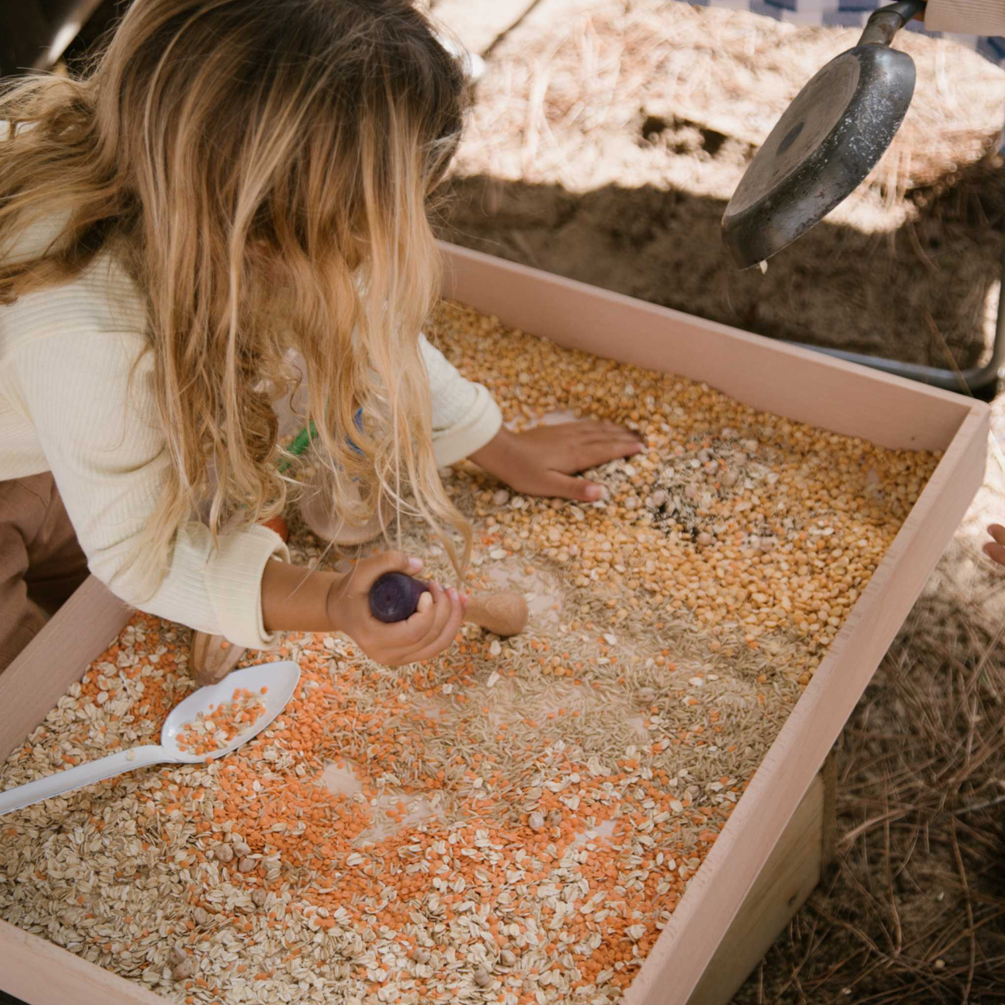 Little Girl Playing With Grapat Tools In Sensory Play