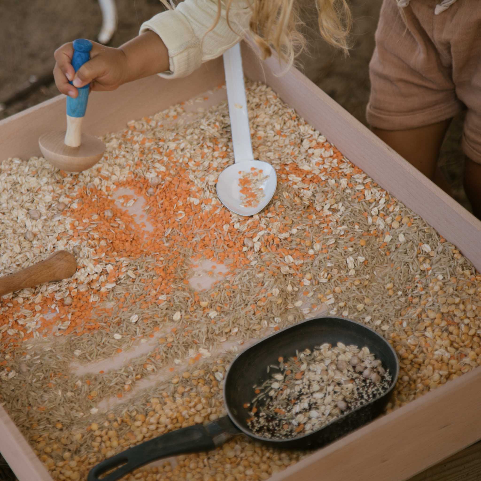 Little Hand Playing With Grapat Tools In Sensory Play 