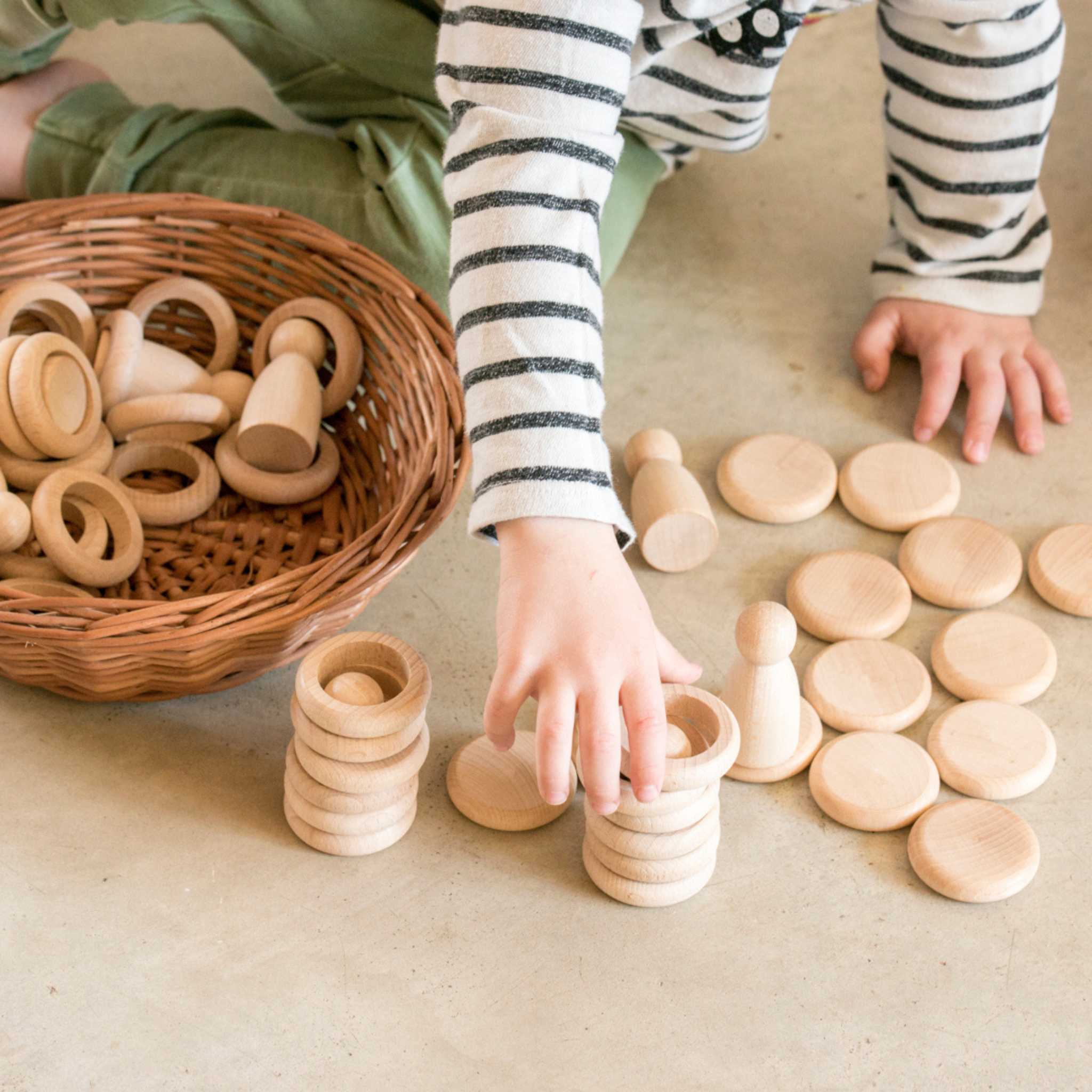 Little Hands Playing With Grapat Nins Rings Coins In Natural