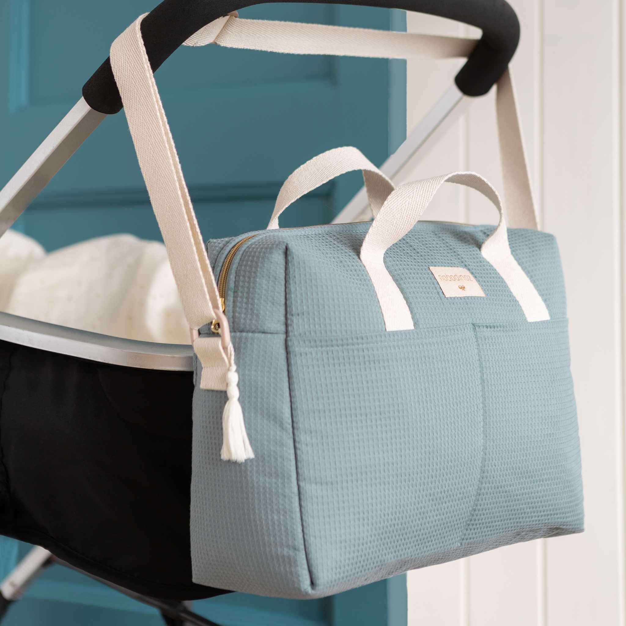 Nobodinoz Gala Changing Bag - Stone Blue - Hanging Over Pram Handles