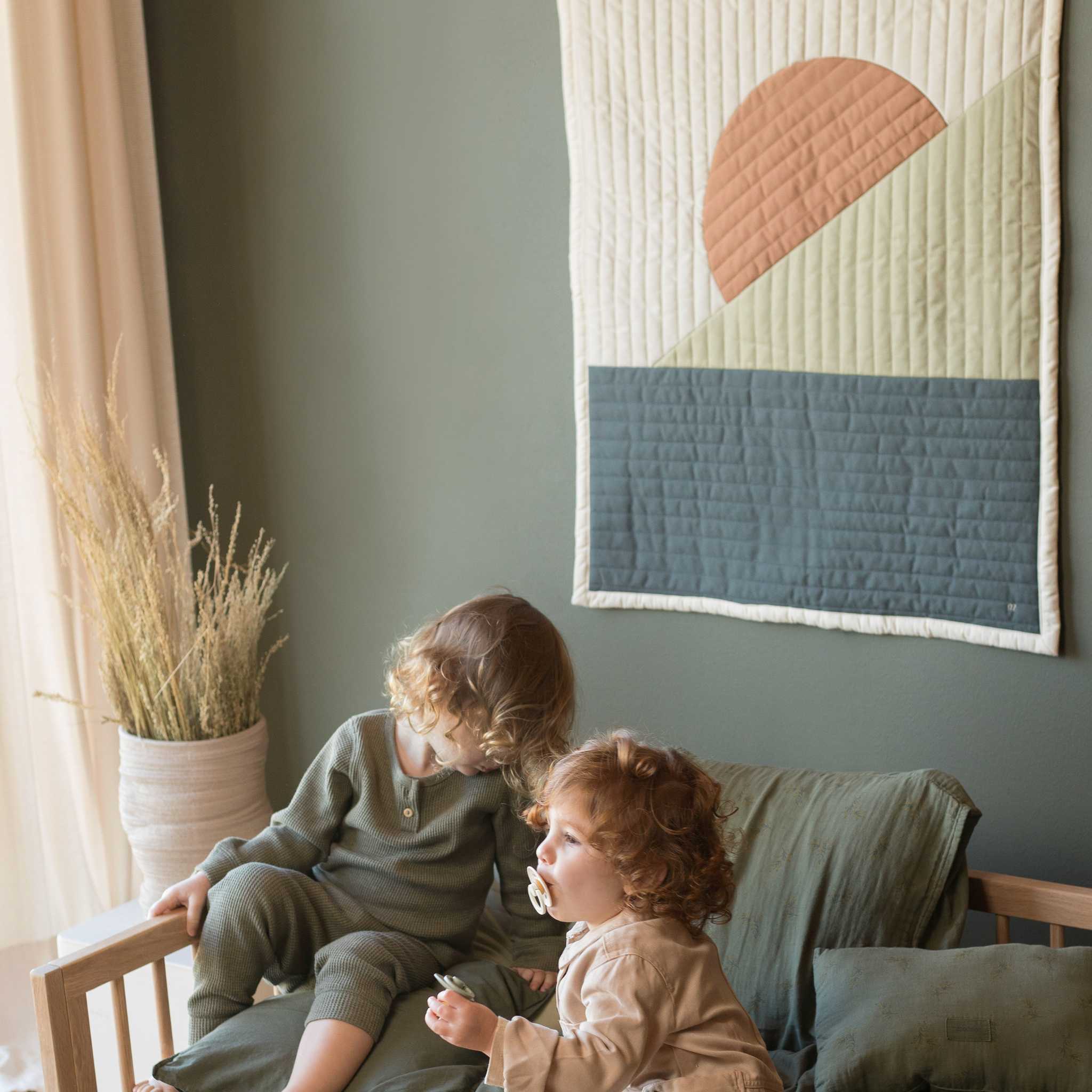 Nododinoz Landscape Quilted Blanket On Wall Behind Children