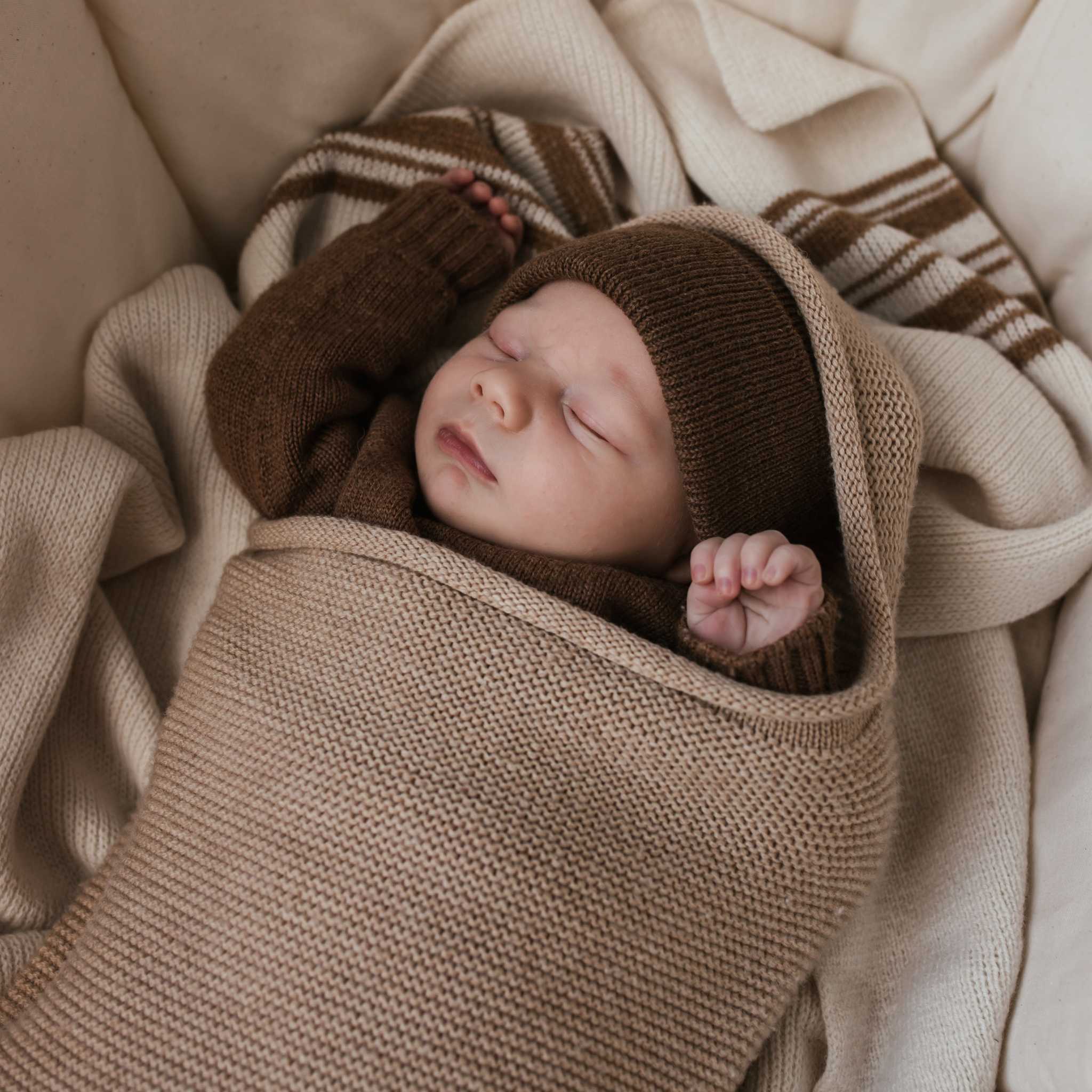 Sleeping Baby In Hvid Merino Wool Cocoon In Sand