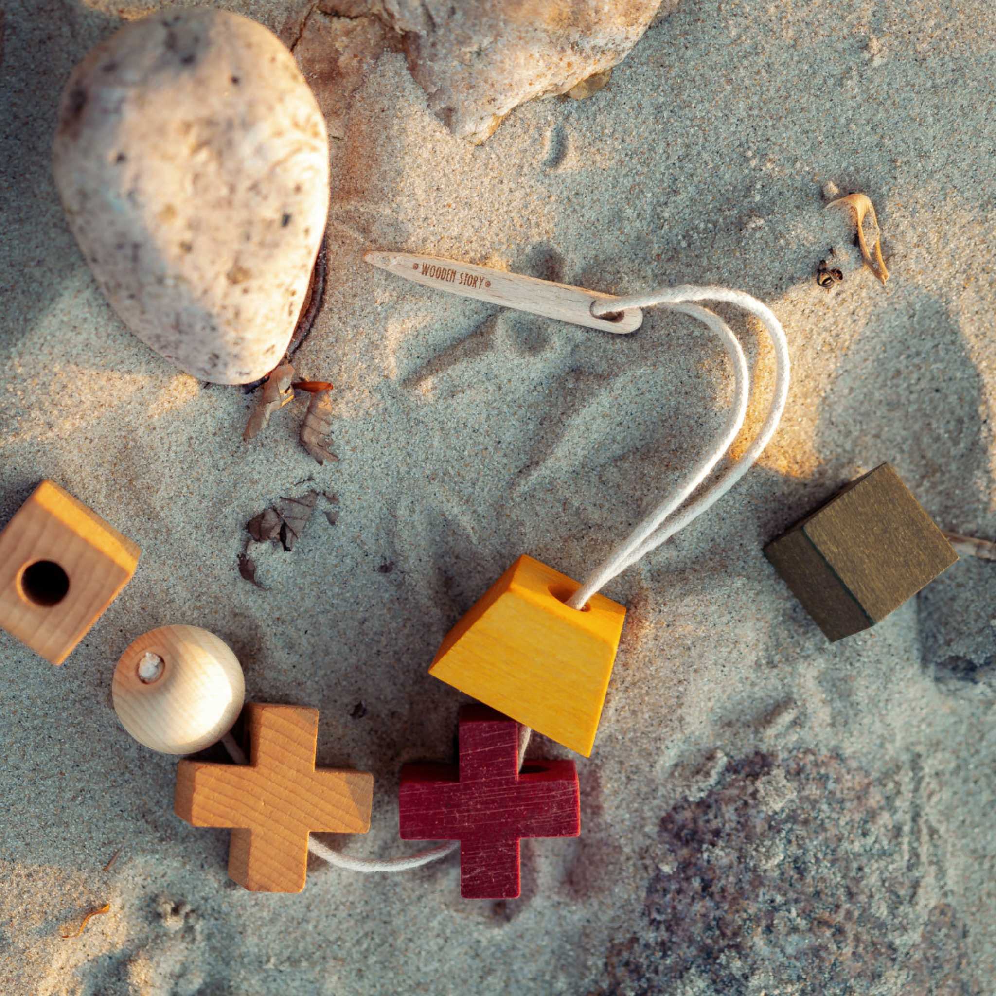 Wooden Story Wooden Needle On Sand With Blocks 