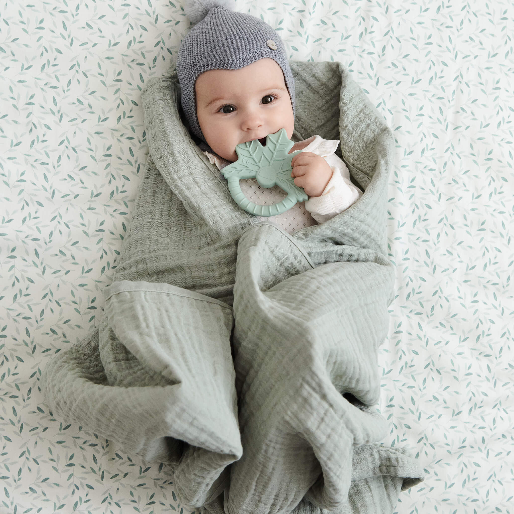 Baby with Cam Cam Copenhagen Leaf Shaped Teether in Dusty Green