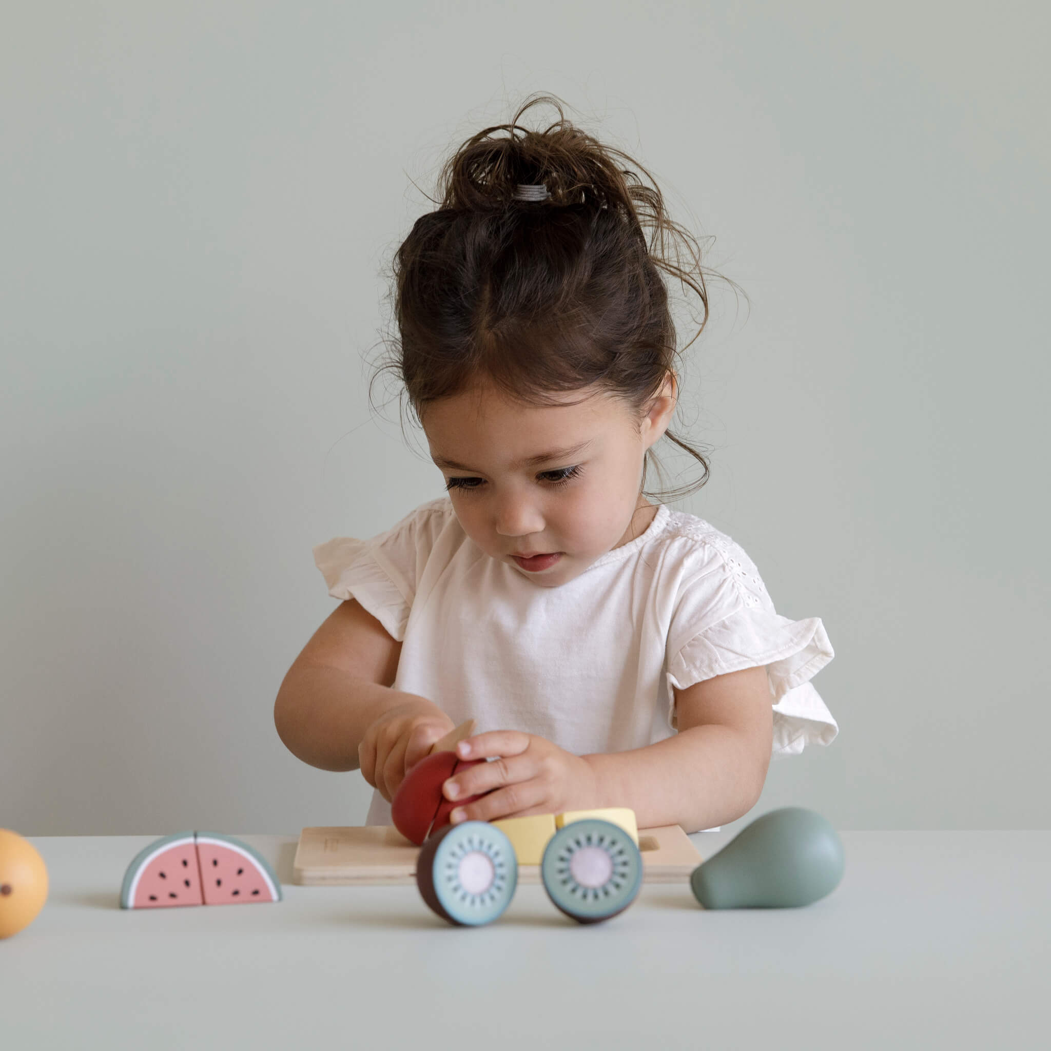 Girl cutting Little Dutch Wooden Cutting Fruit Set