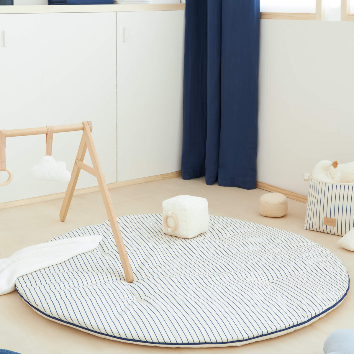 Nobodinoz Fluffy Round Playmat in Blue Stripes in Room
