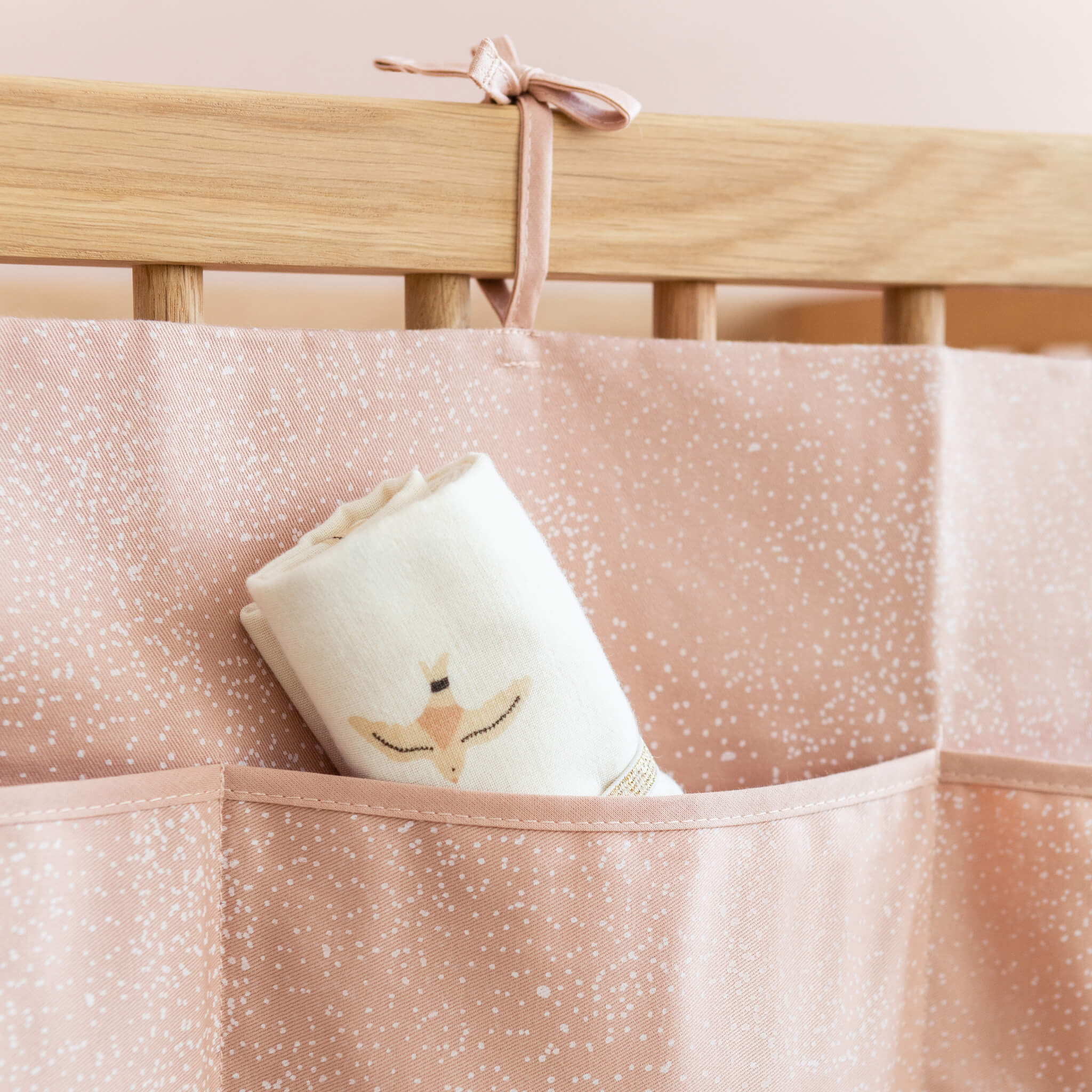 Nobodinoz Merlin Crib Organiser in Bubble Pink on Cot