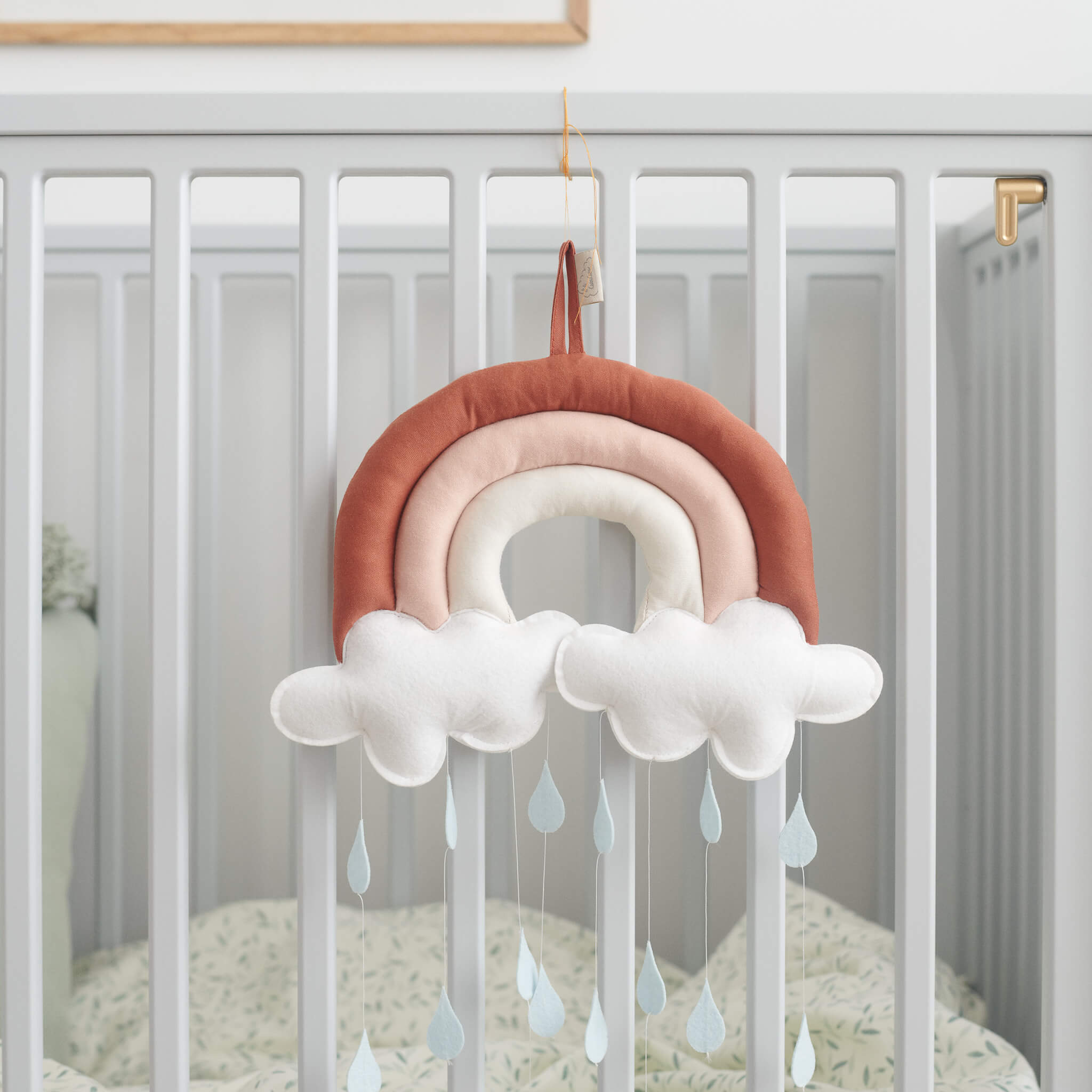 Cam Cam Copenhagen Rainbow Mobile in Caramel on Cot