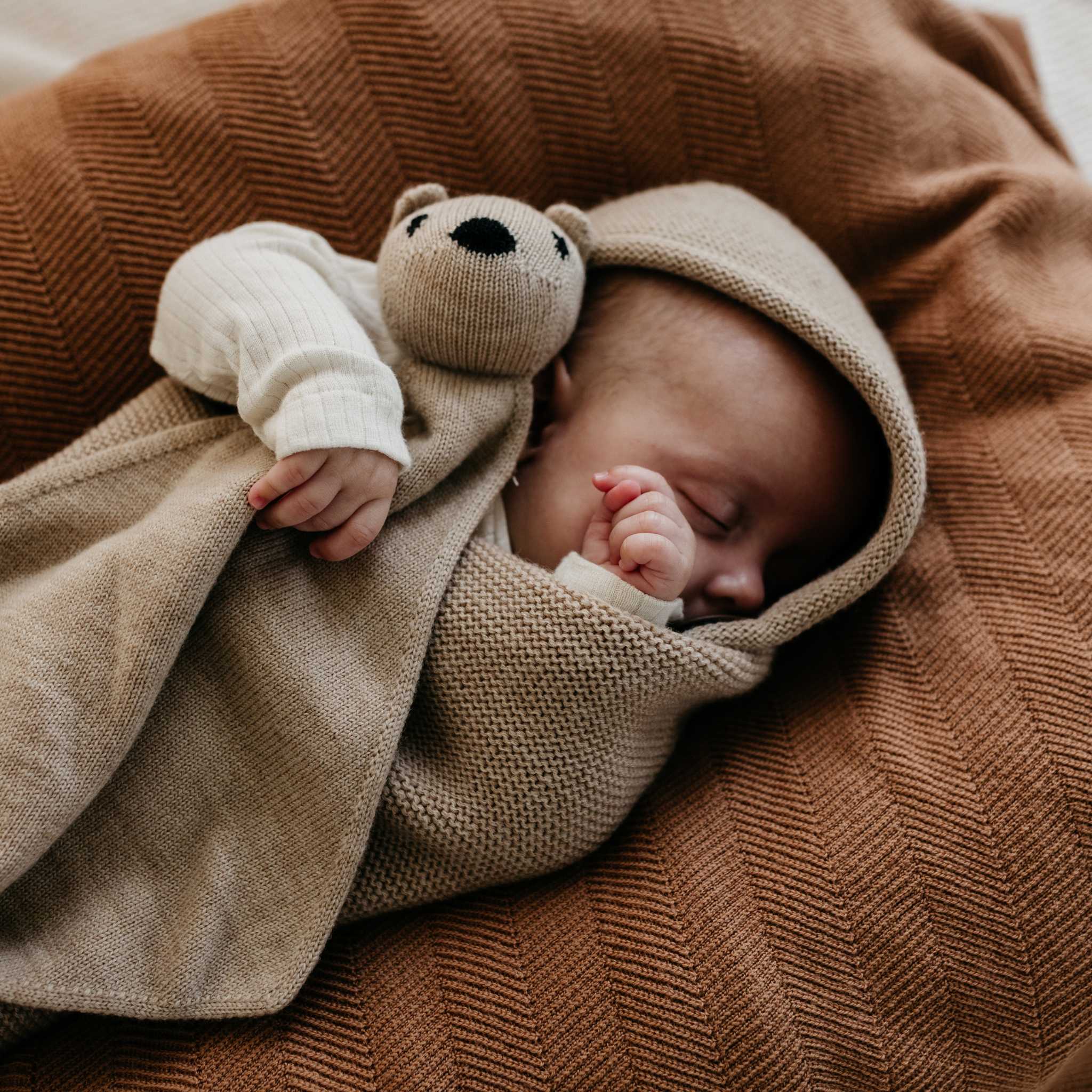 Baby Sleeping In Hvid Merino Wool Cocoon In Sand