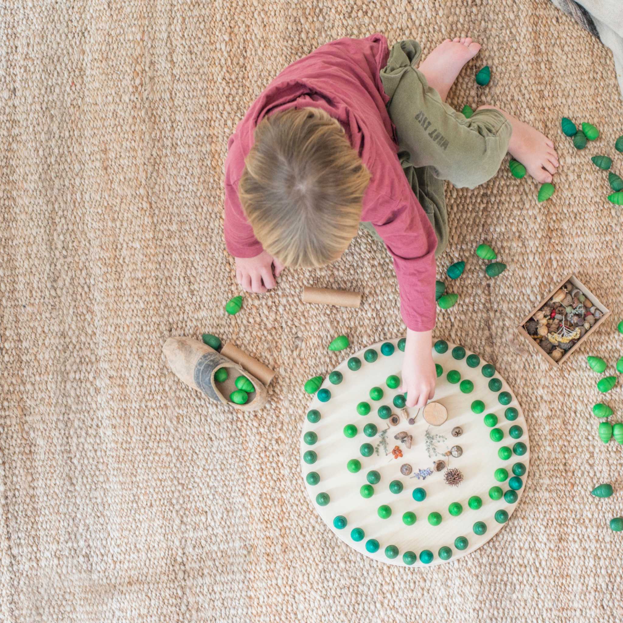 Boy Playing With Grapat Mandala Trees And Other Pieces