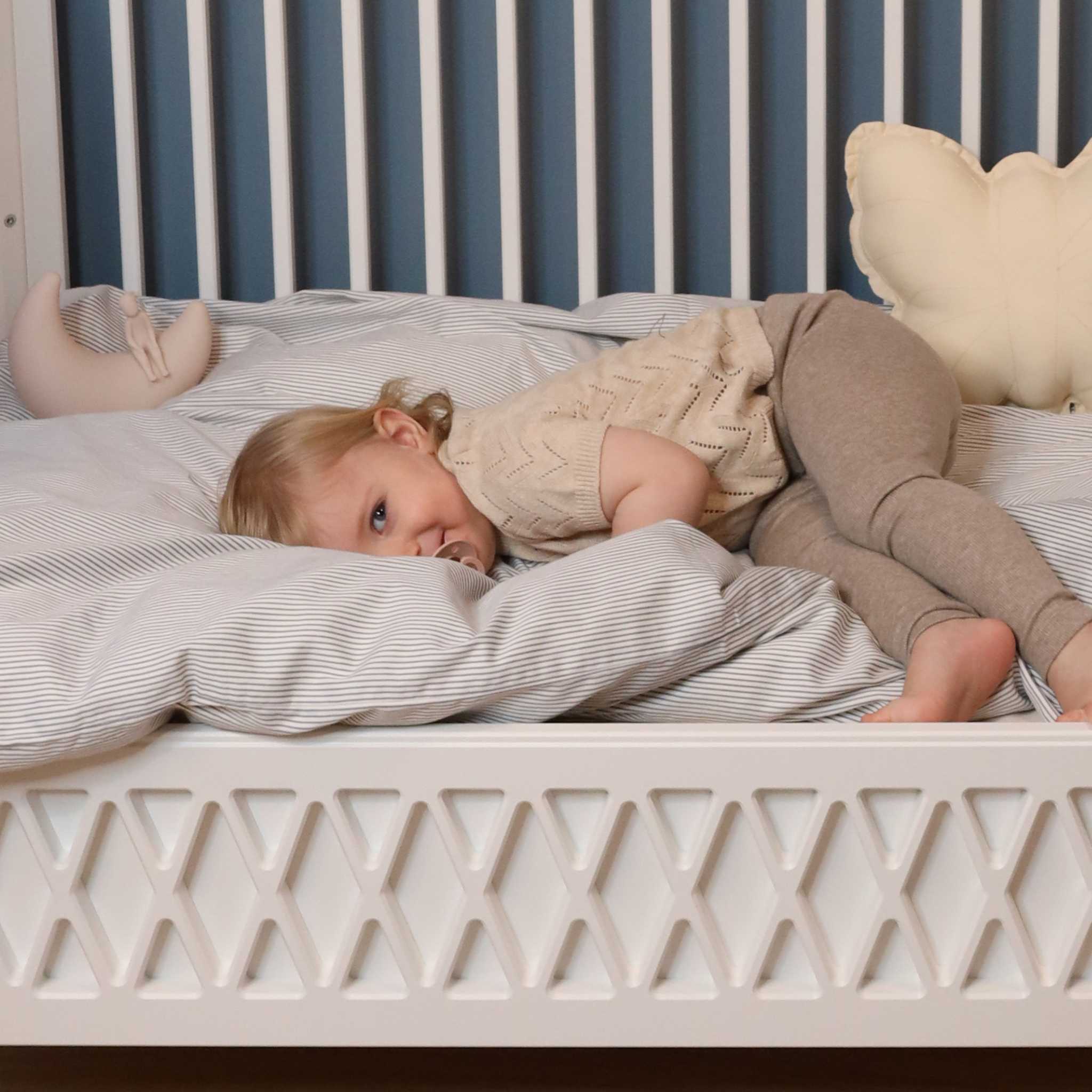 Cam Cam Copenhagen Toddler Bedding In Blue Stripe In Cot With Child