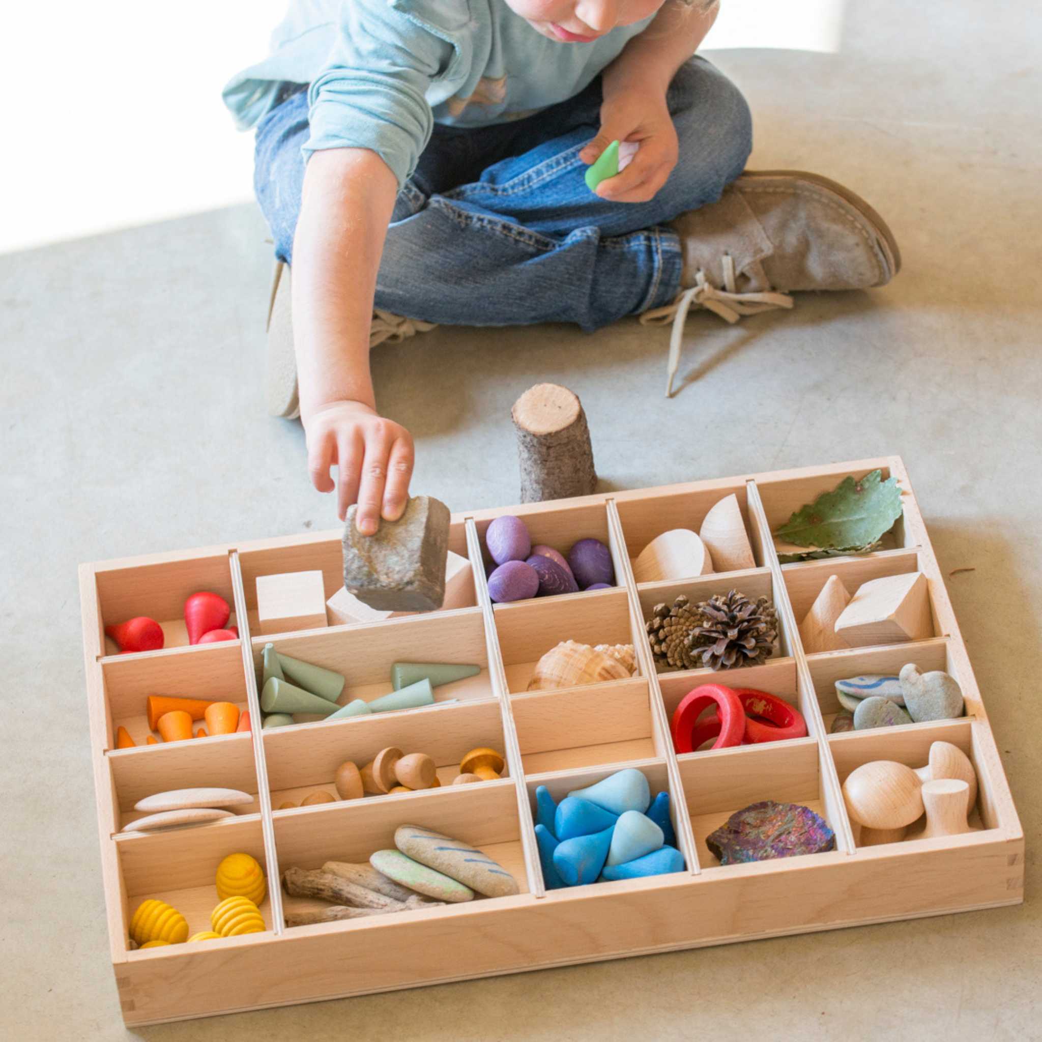 Child Playing with Grapat Tinker Tray