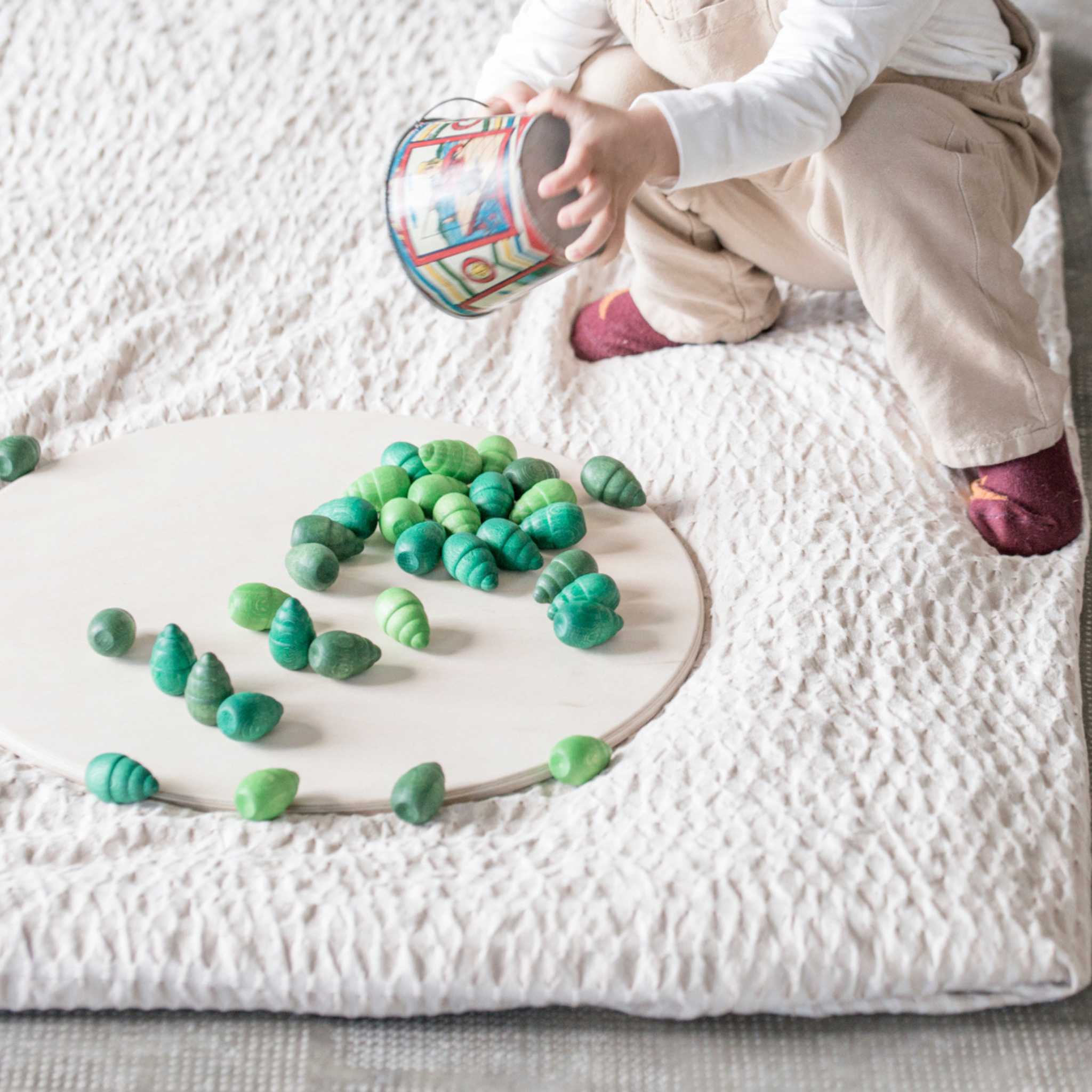 Child Playing With Grapat Mandala Trees On Blanket