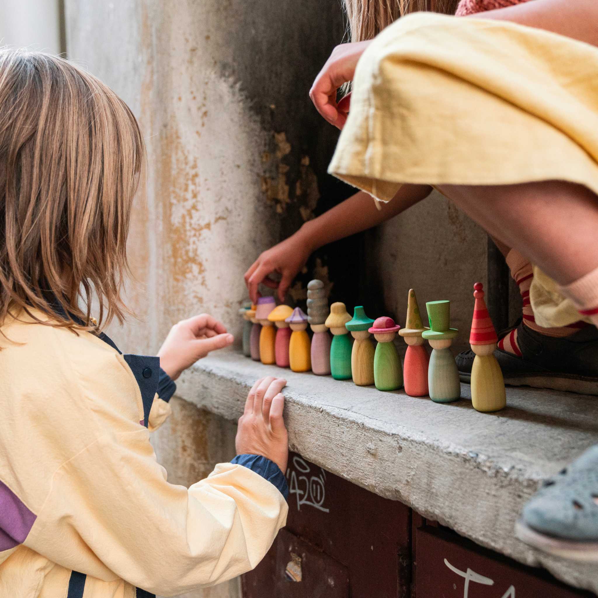 Children Playing With Grapat Fancy Nins, Wooden Figures Outside