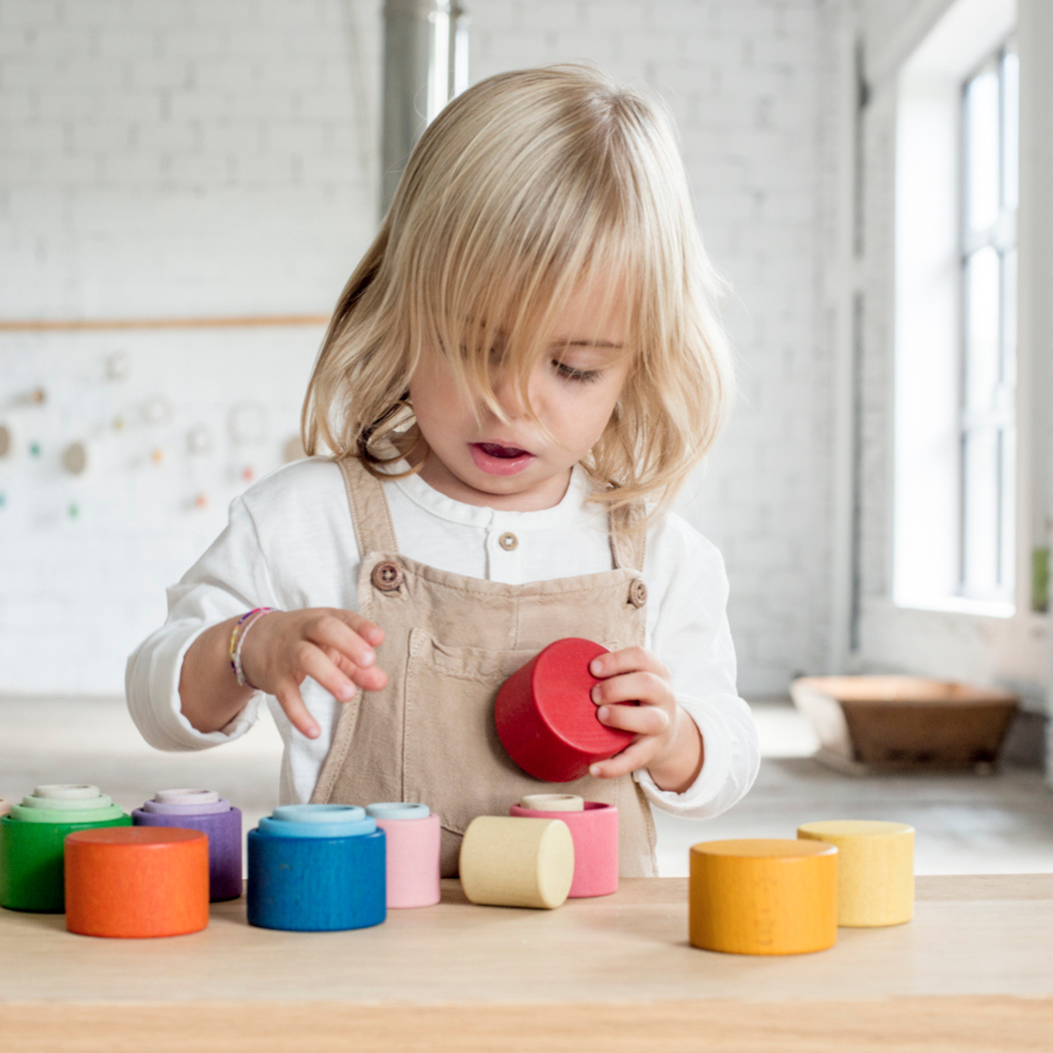 Girl Playing With Grapat Nesting Bowls