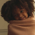 Little Girl Wrapped in Hvid Felix Merino Wool Blanket in Rose