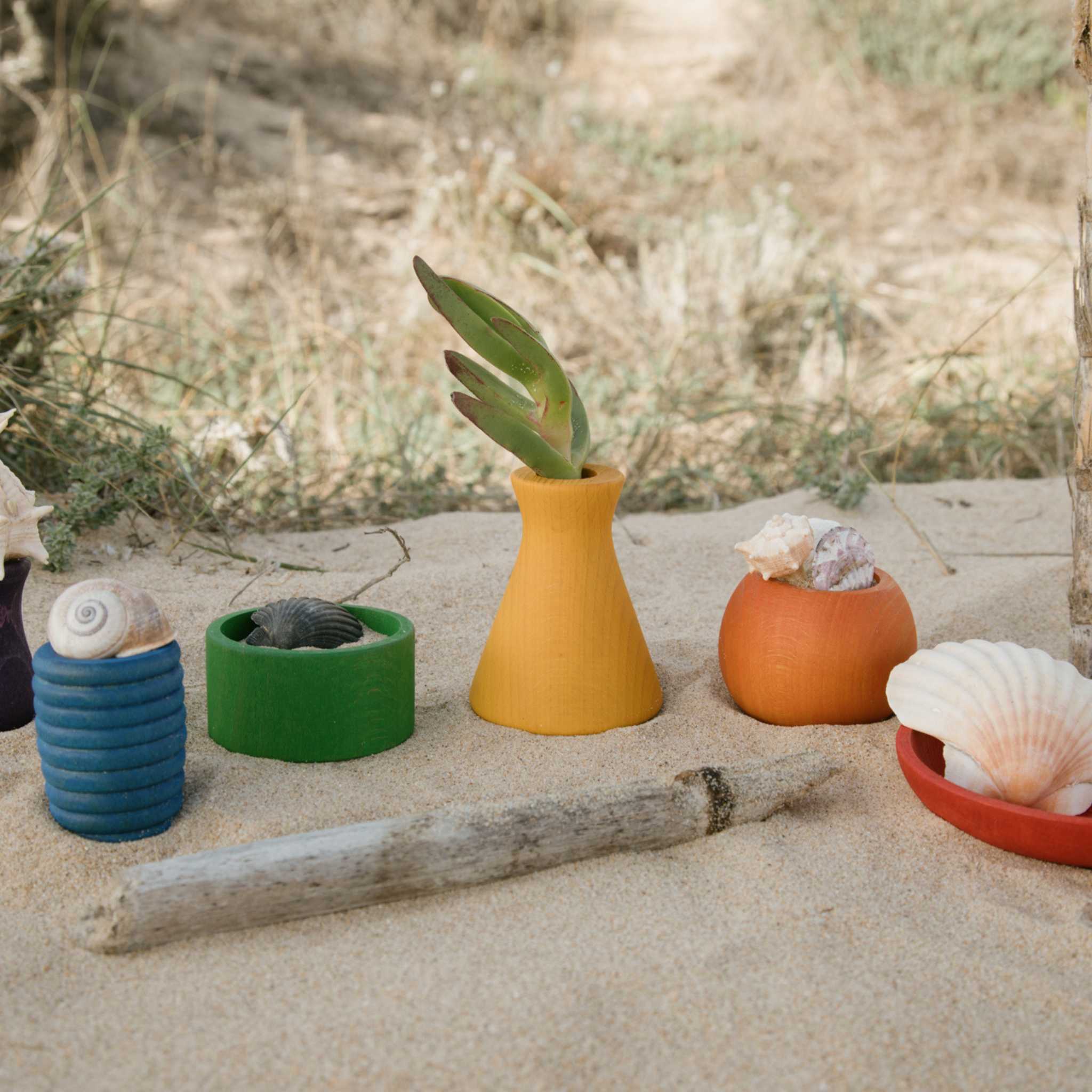 Grapat Pots On Beach Filled With Seaside Treasures 