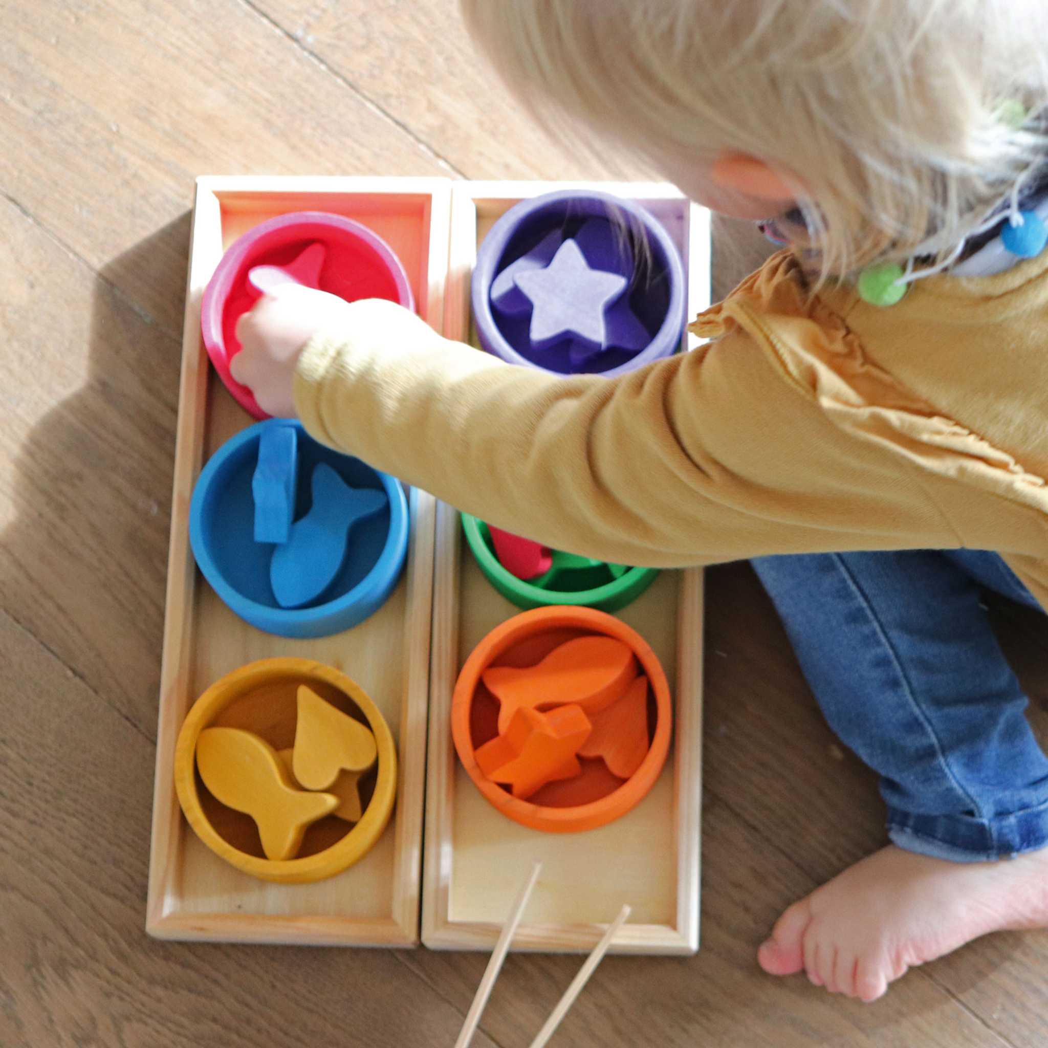 Child Playing With Grimm's Rainbow Bowls Sorting Game