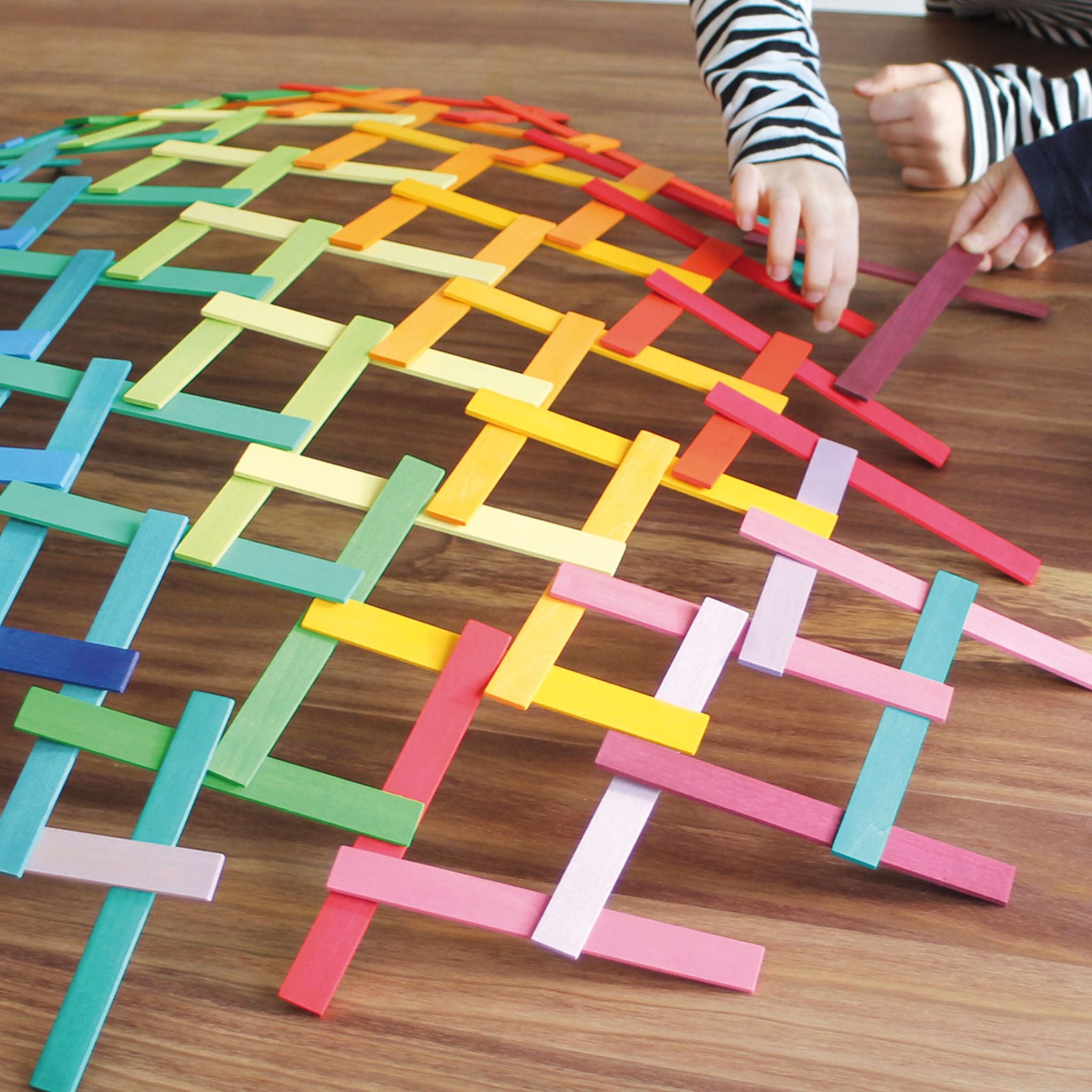 Child Playing With Grimm's Leonardo Wooden Sticks