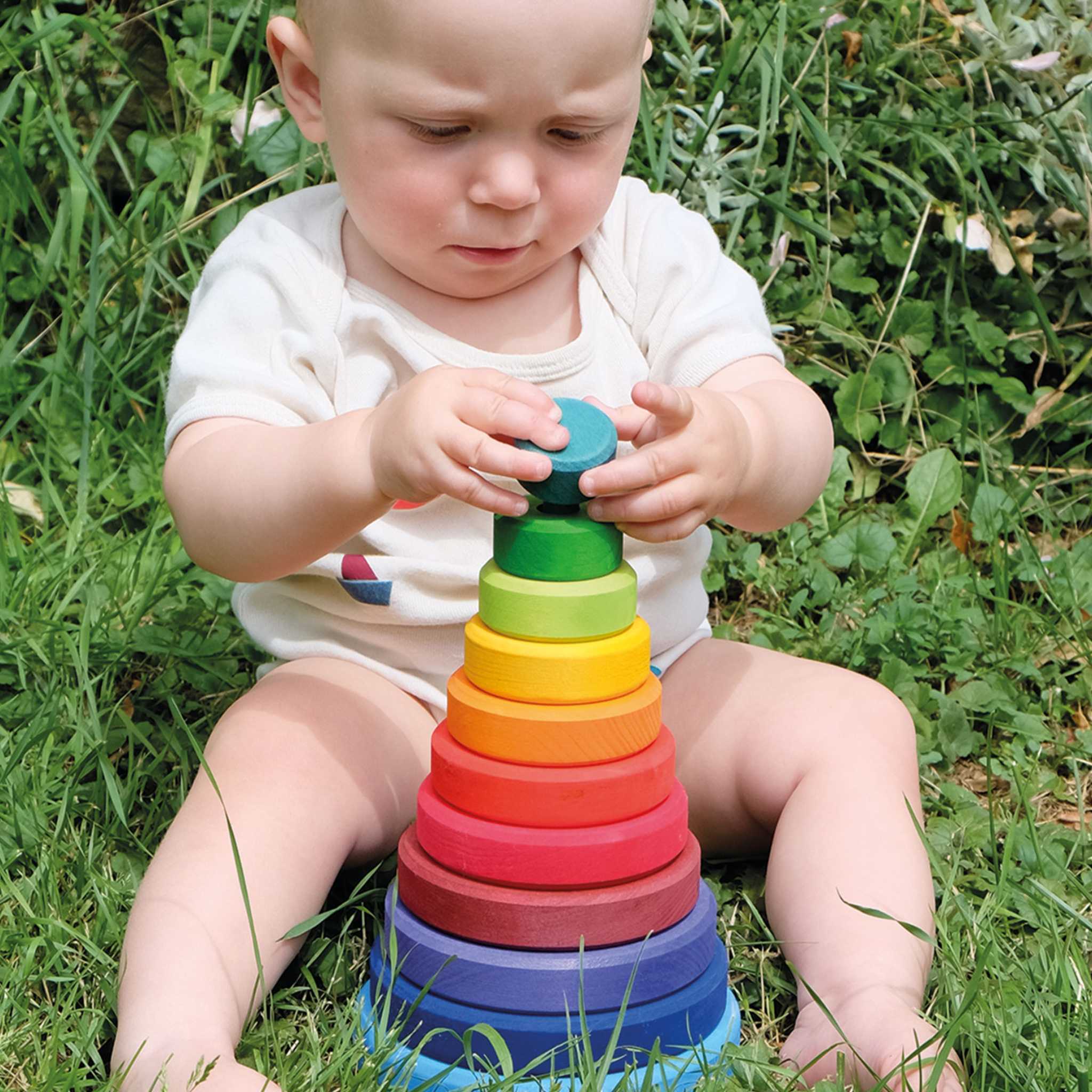 Child Playing With Grimm's Large Conical Stacking Tower