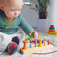 Child Playing with Grimm's Thread Game Small Bobbins