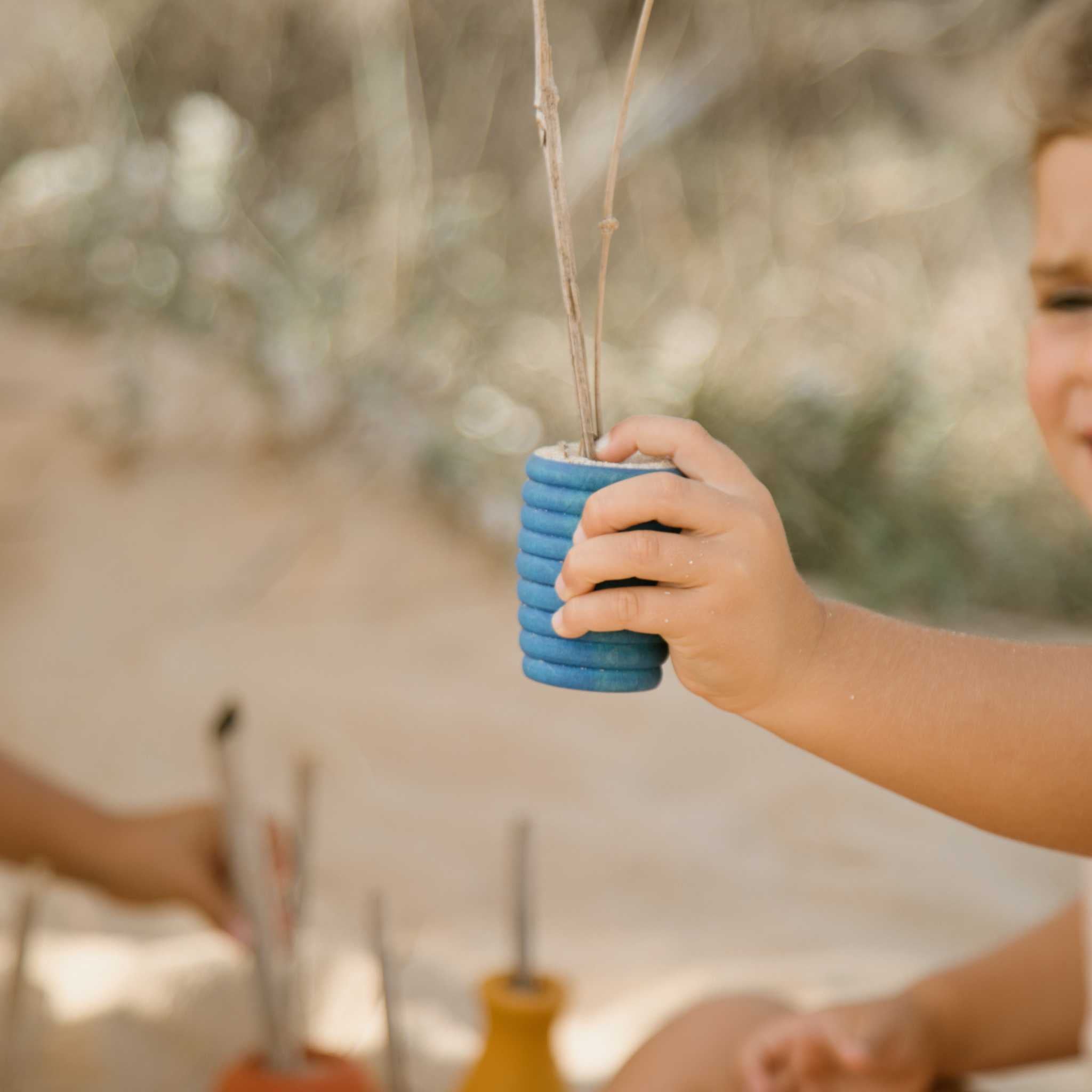Little Boy Playing With Grapat Blue Pot