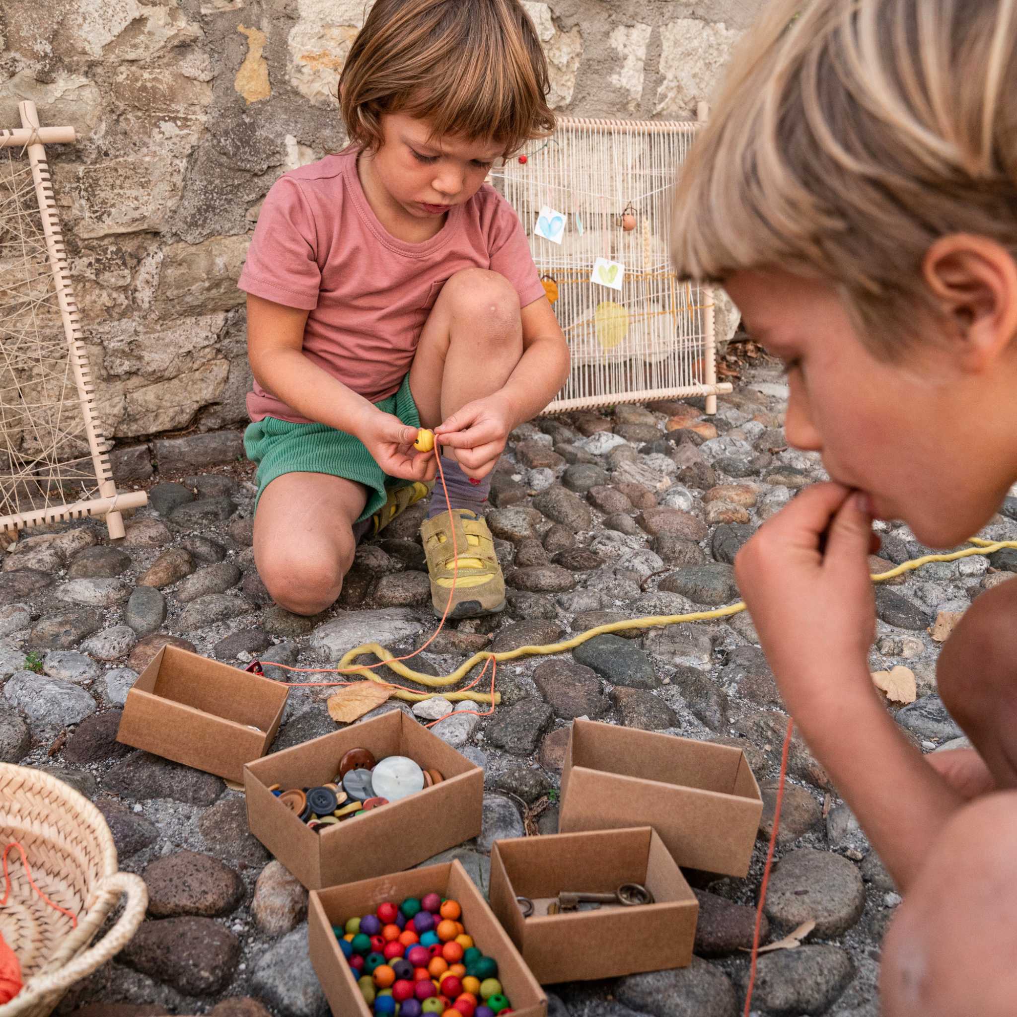 Boys Playing With Grapat Weaving Frame
