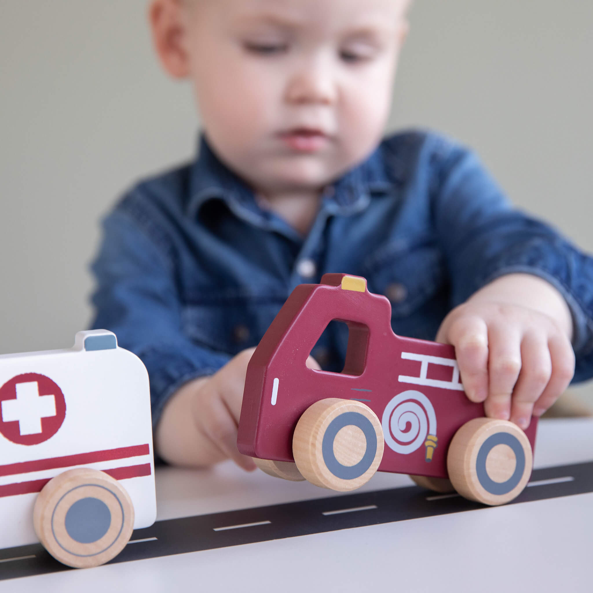 Boy Playing with Little Dutch Wooden Emergency Service Vehicles