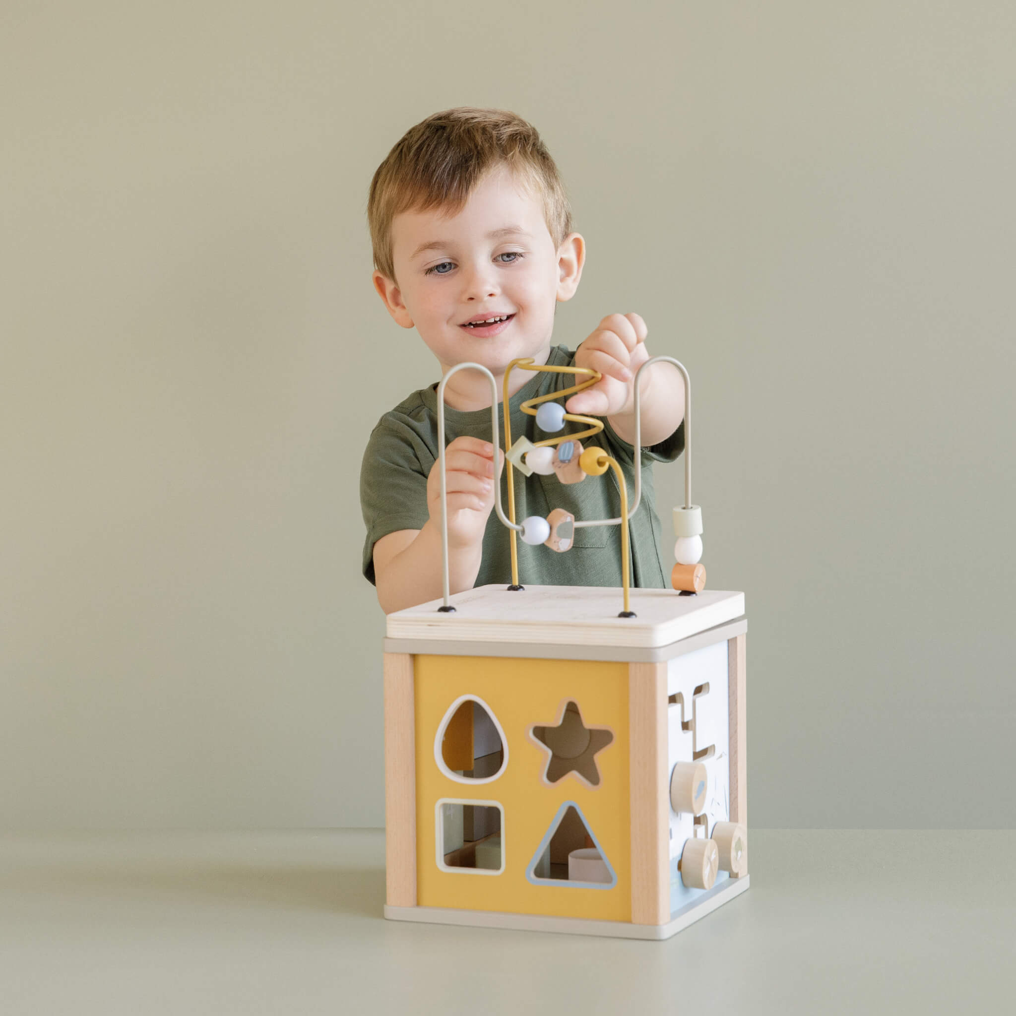 Boy Playing with Little Dutch Wooden Activity Cube Toy in Little Goose Design