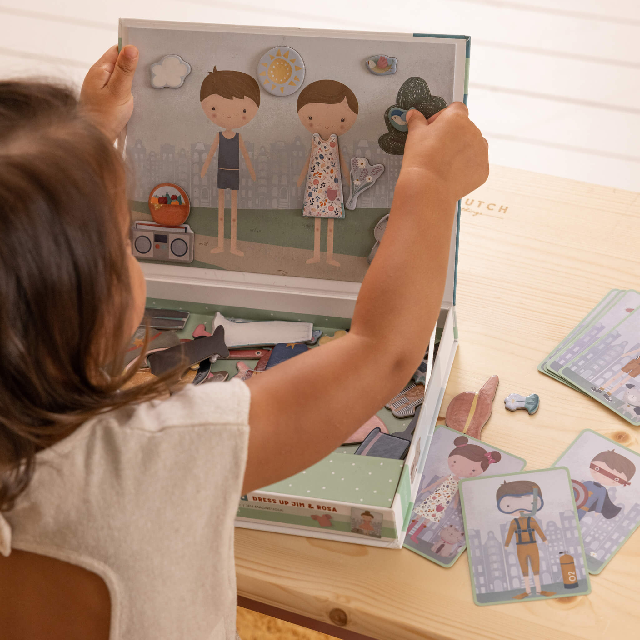 Girl Playing Little Dutch Magnetic Playboard - Jim and Rosa Dress Up