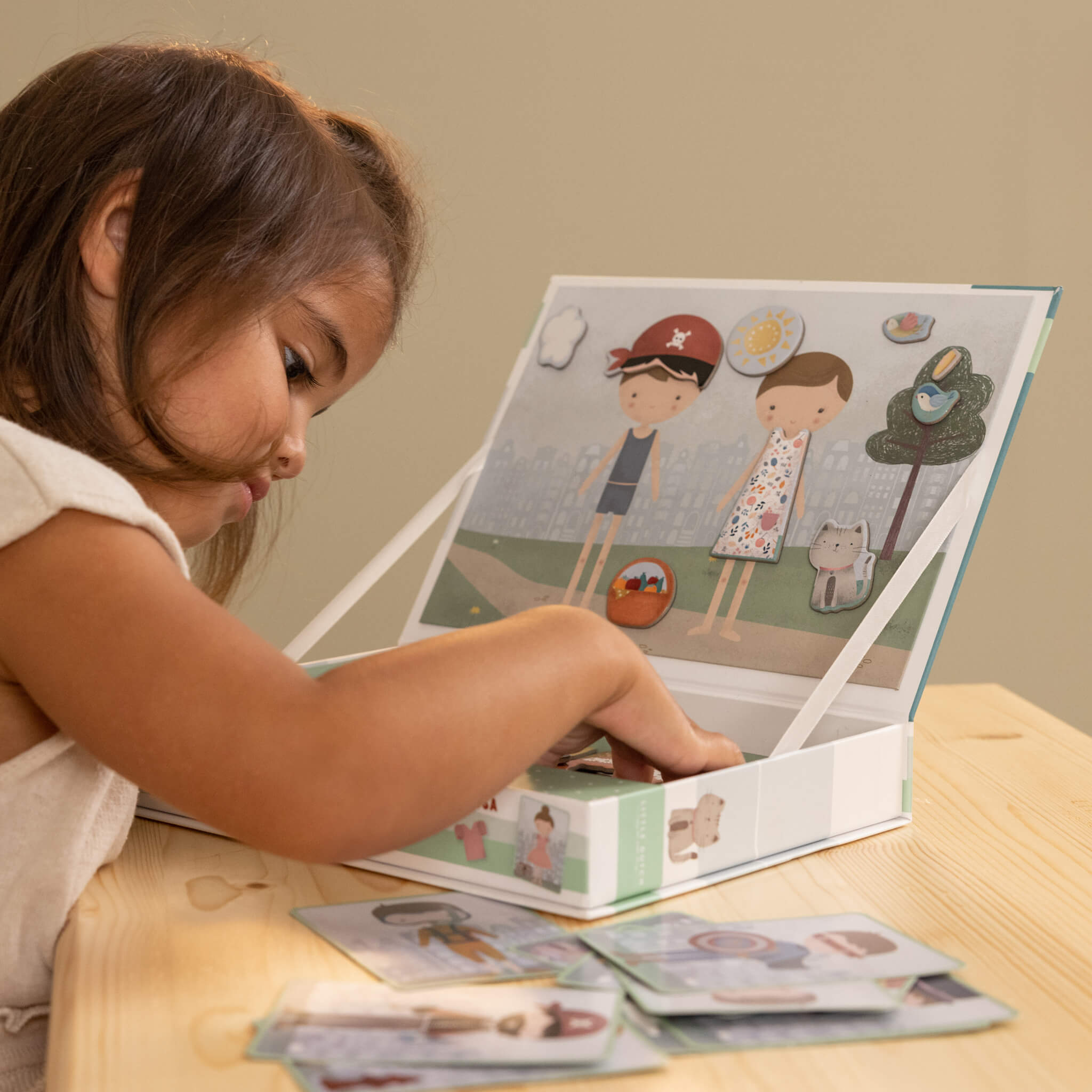 Girl Playing Little Dutch Magnetic Playboard - Jim and Rosa Dress Up