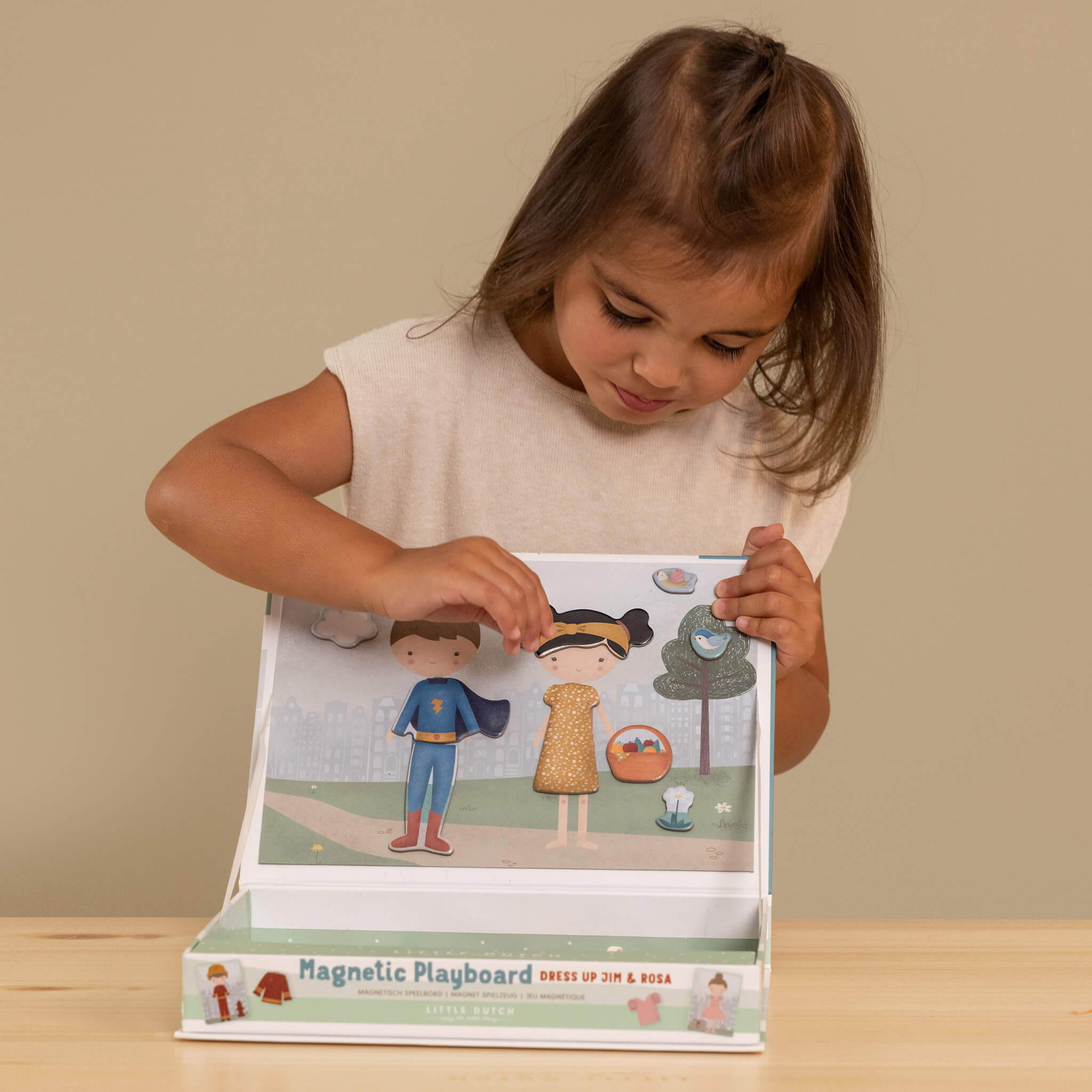 Girl Playing Little Dutch Magnetic Playboard - Jim and Rosa Dress Up
