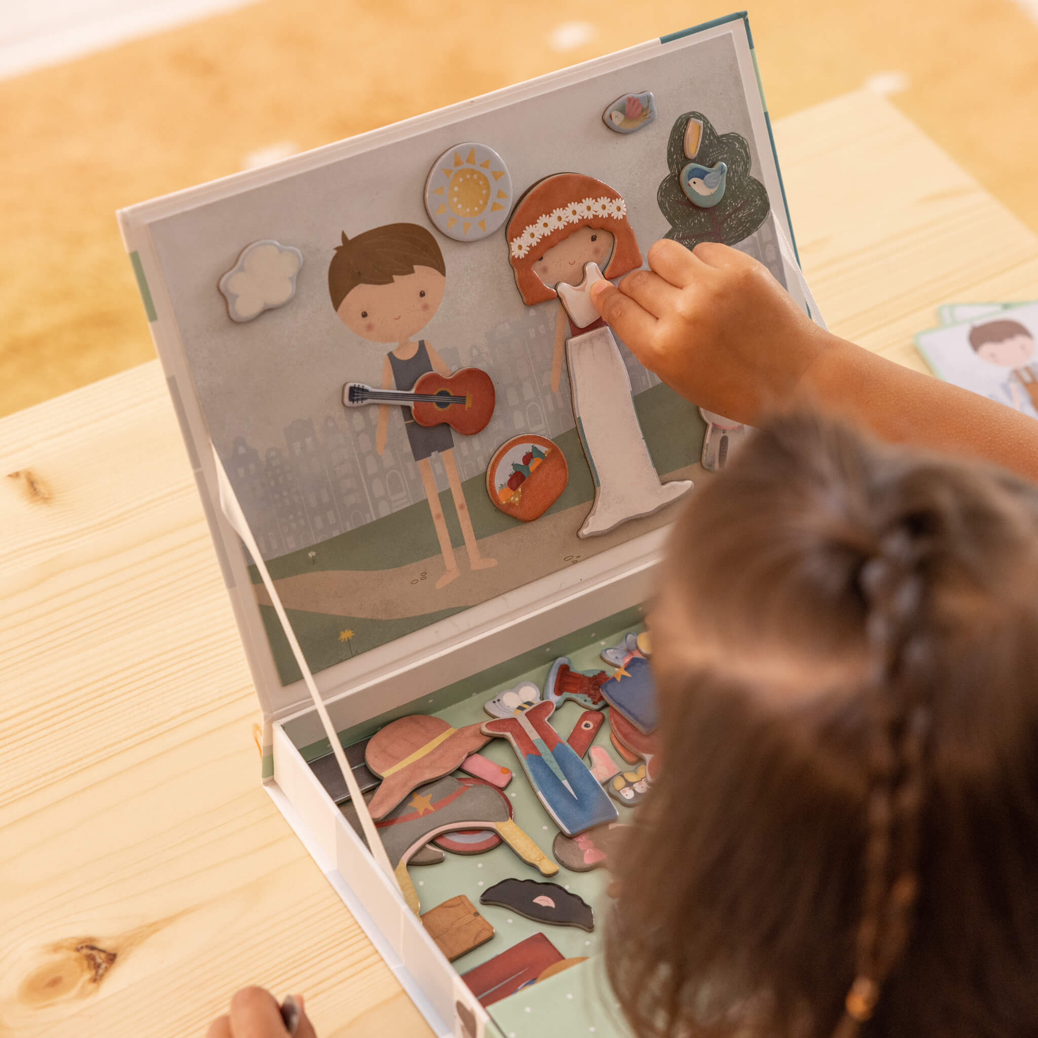 Girl Playing Little Dutch Magnetic Playboard - Jim and Rosa Dress Up