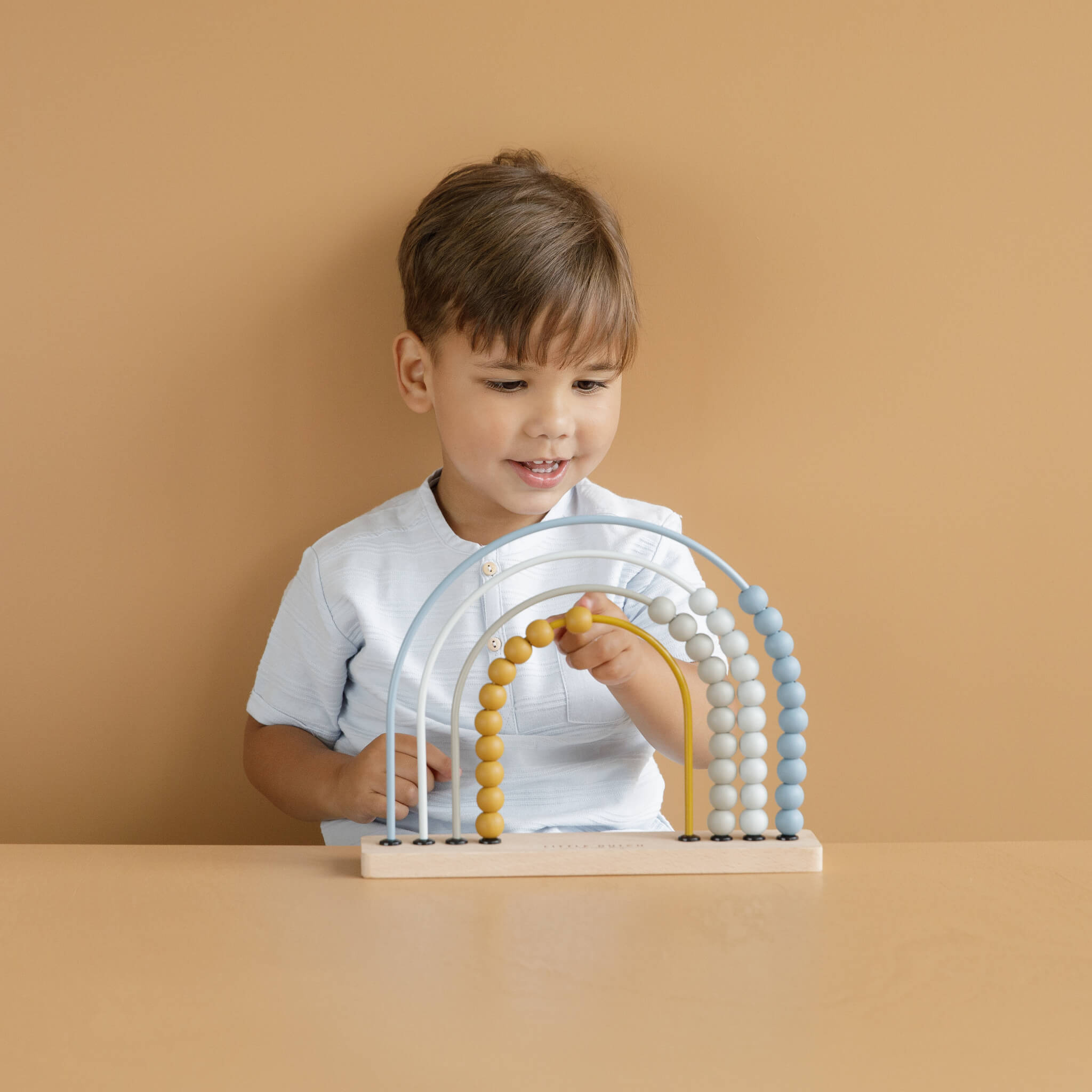 Boy with Little Dutch Rainbow Abacus Toy in Blue