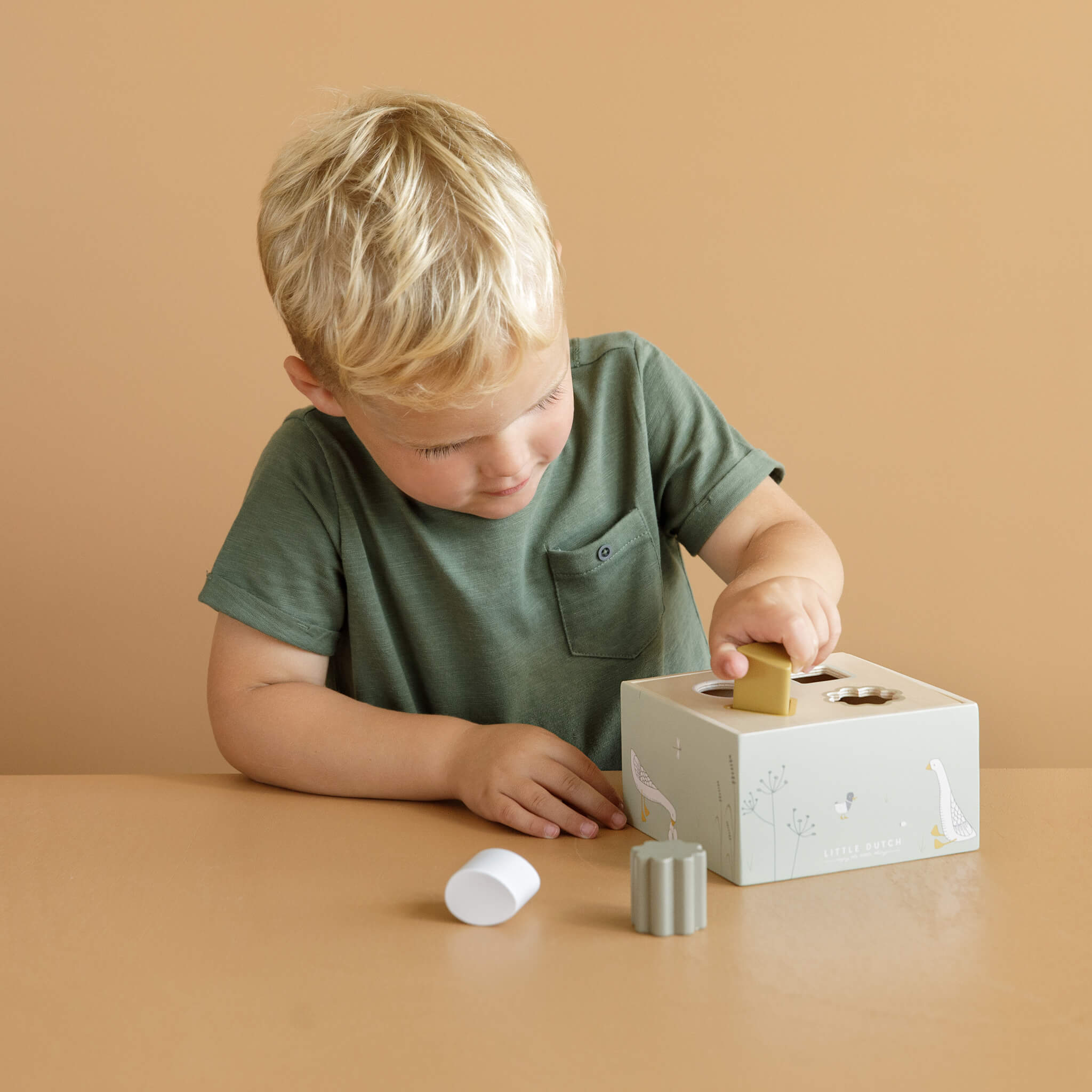 Boy Playing with Little Dutch Shape Sorter in Little Goose