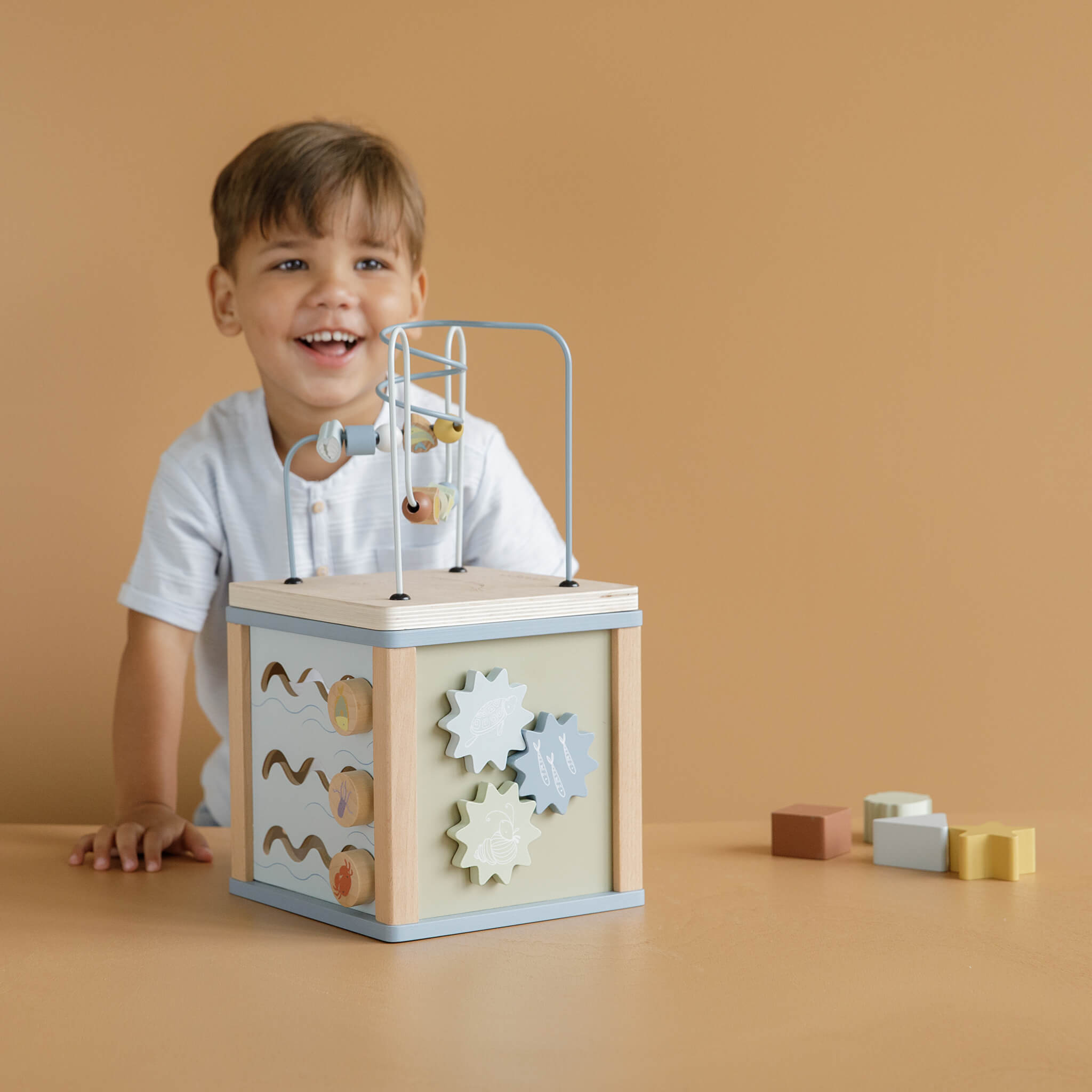 Boy Playing with Little Dutch Wooden Activity Cube Toy in Ocean Design