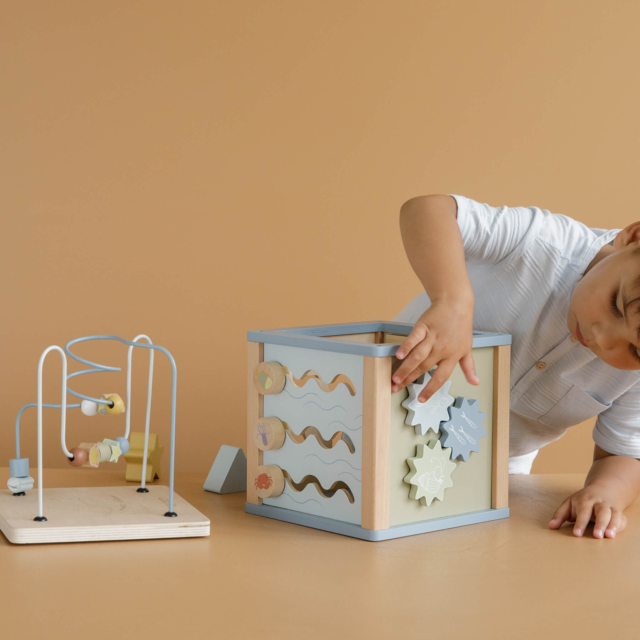 Boy Playing with Little Dutch Wooden Activity Cube Toy in Ocean Design