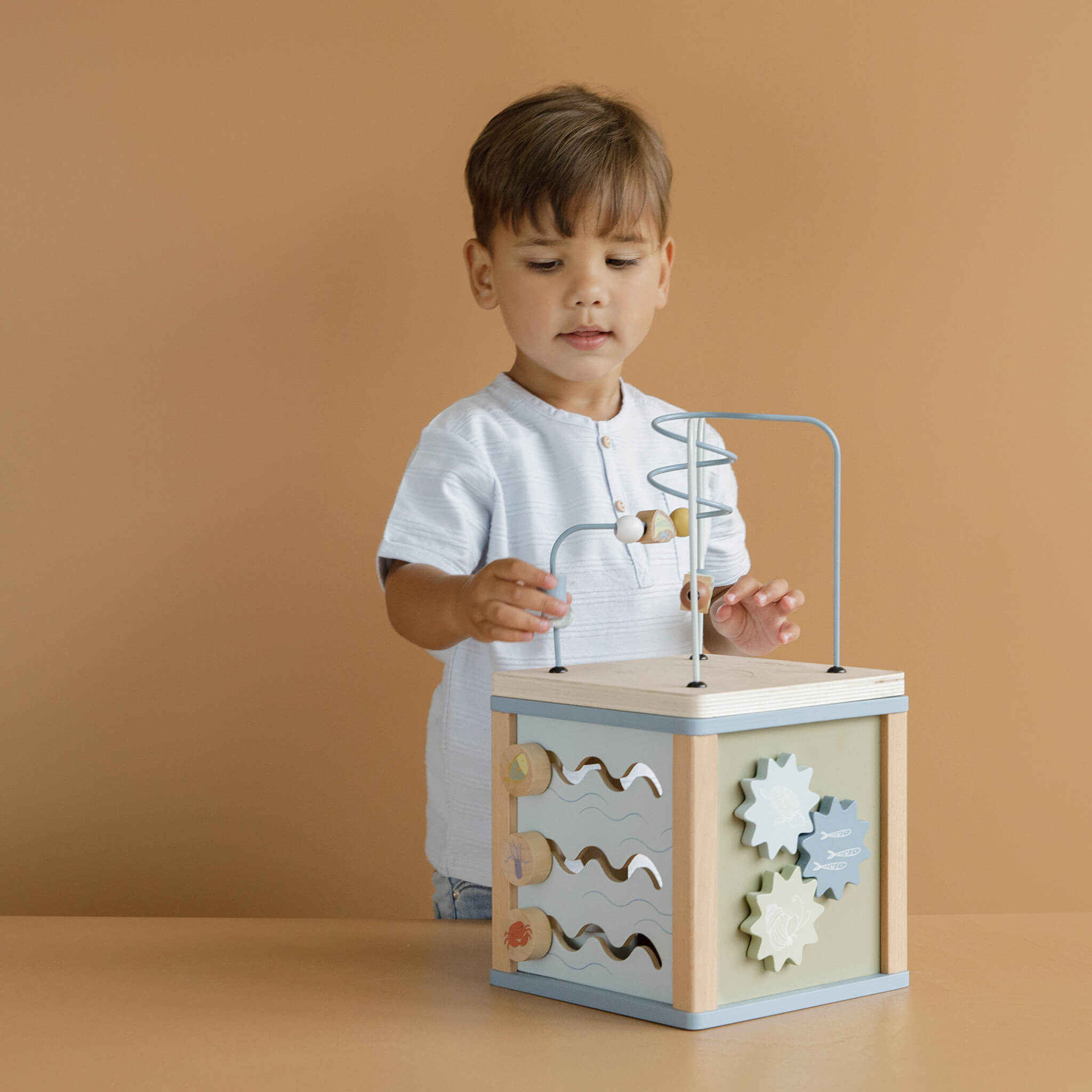 Boy Playing with Little Dutch Wooden Activity Cube Toy in Ocean Design