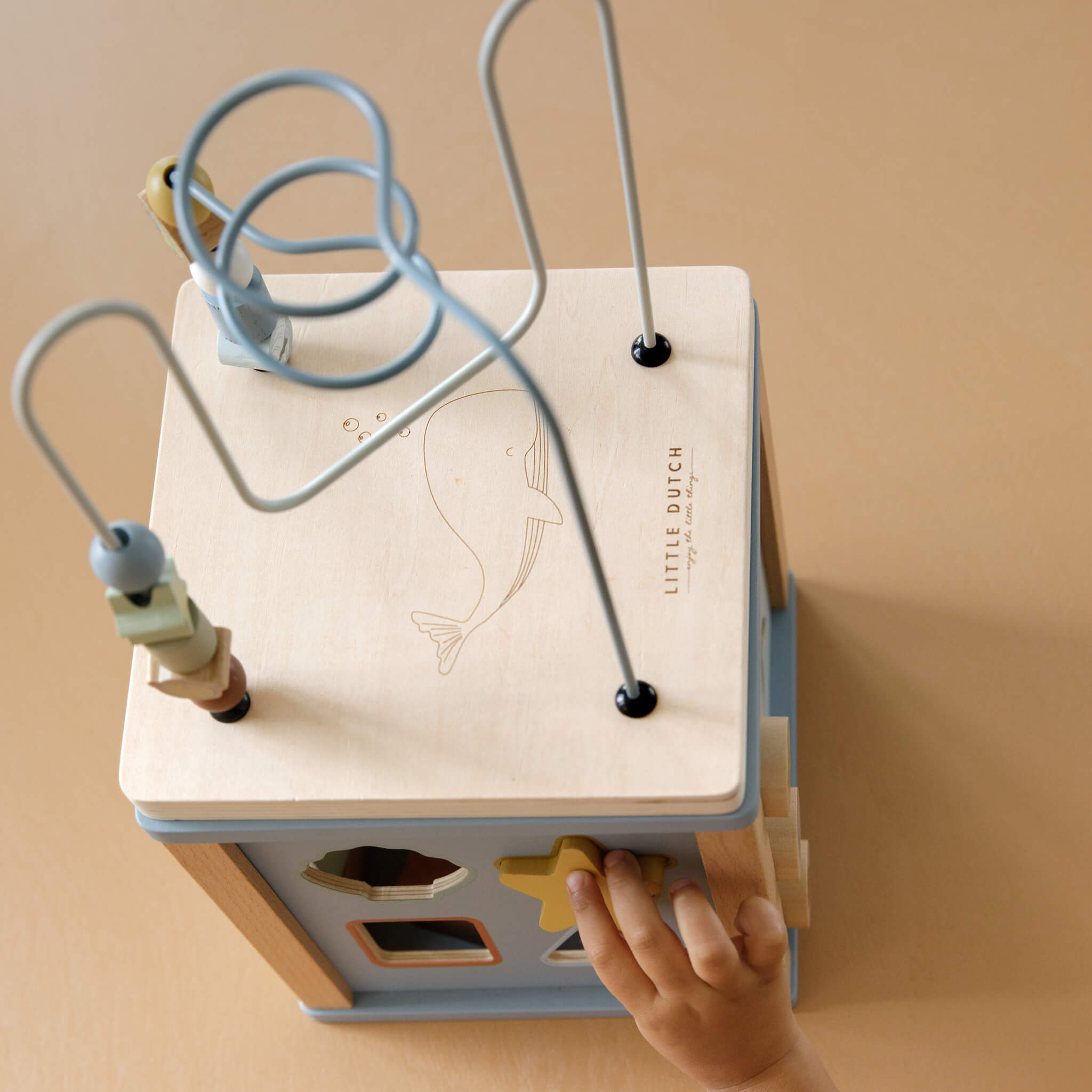 Boy Playing with Little Dutch Wooden Activity Cube Toy in Ocean Design
